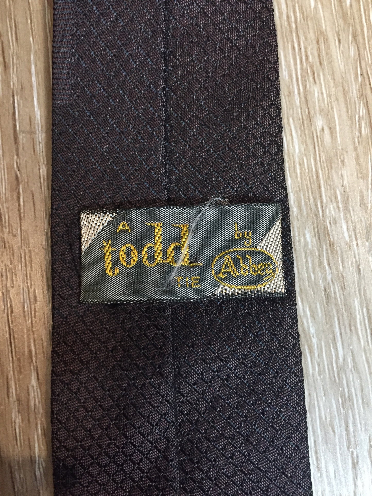 Kingspier Vintage - A Todd by Abbey tie with brown and black design. Fibres unknown.
Length: 56”
Width: 2.5”
This tie is in excellent condition.