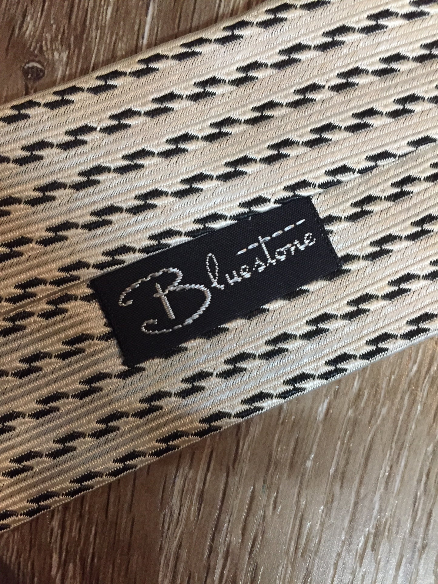 Kingspier Vintage - Bluestone white and black pattern tie. Fibres unknown.
Length: 56.25”
Width: 7.5” 
This tie is in great condition with some slight yellowing.