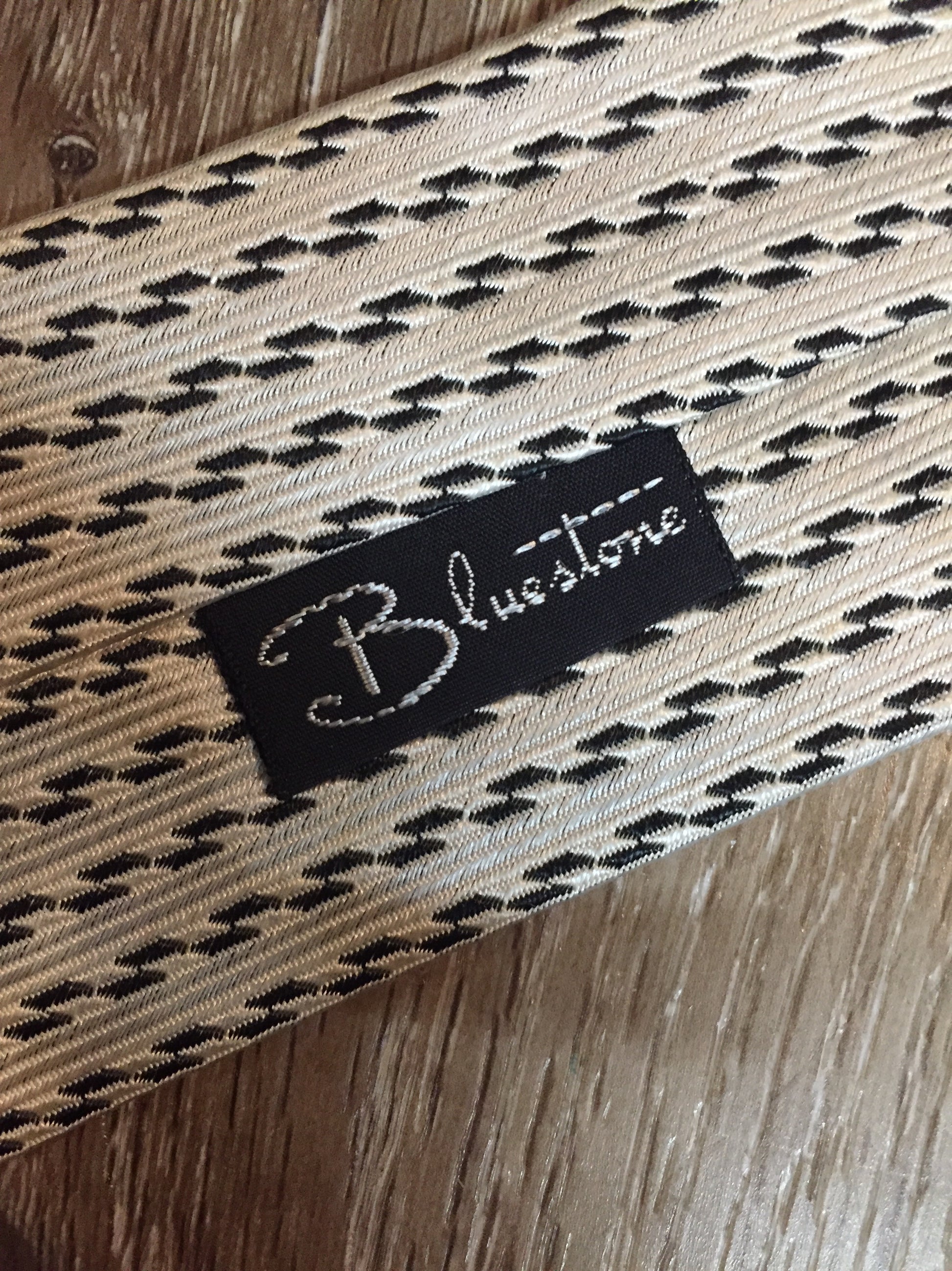 Kingspier Vintage - Bluestone white and black pattern tie. Fibres unknown.
Length: 56.25”
Width: 7.5” 
This tie is in great condition with some slight yellowing.