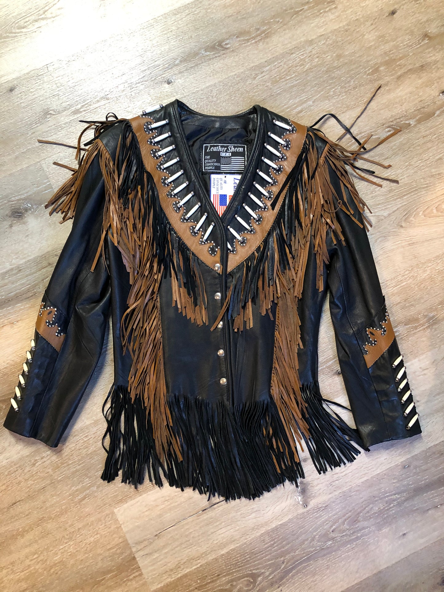 Kingspier Vintage - Sheen black leather jacket with fringe and beaded detail. Made in the USA. Size large.