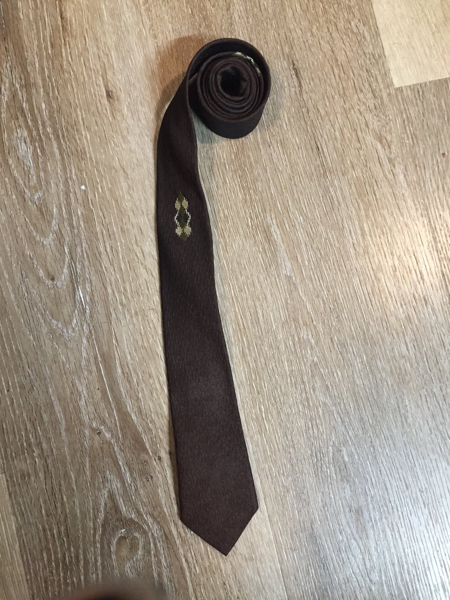 Kingspier Vintage - Fifth Avenue brown tie with white, green and brown diamond motif. Fibres unknown.
Length: 57” 
Width: 2.25” 
This tie is in excellent condition.