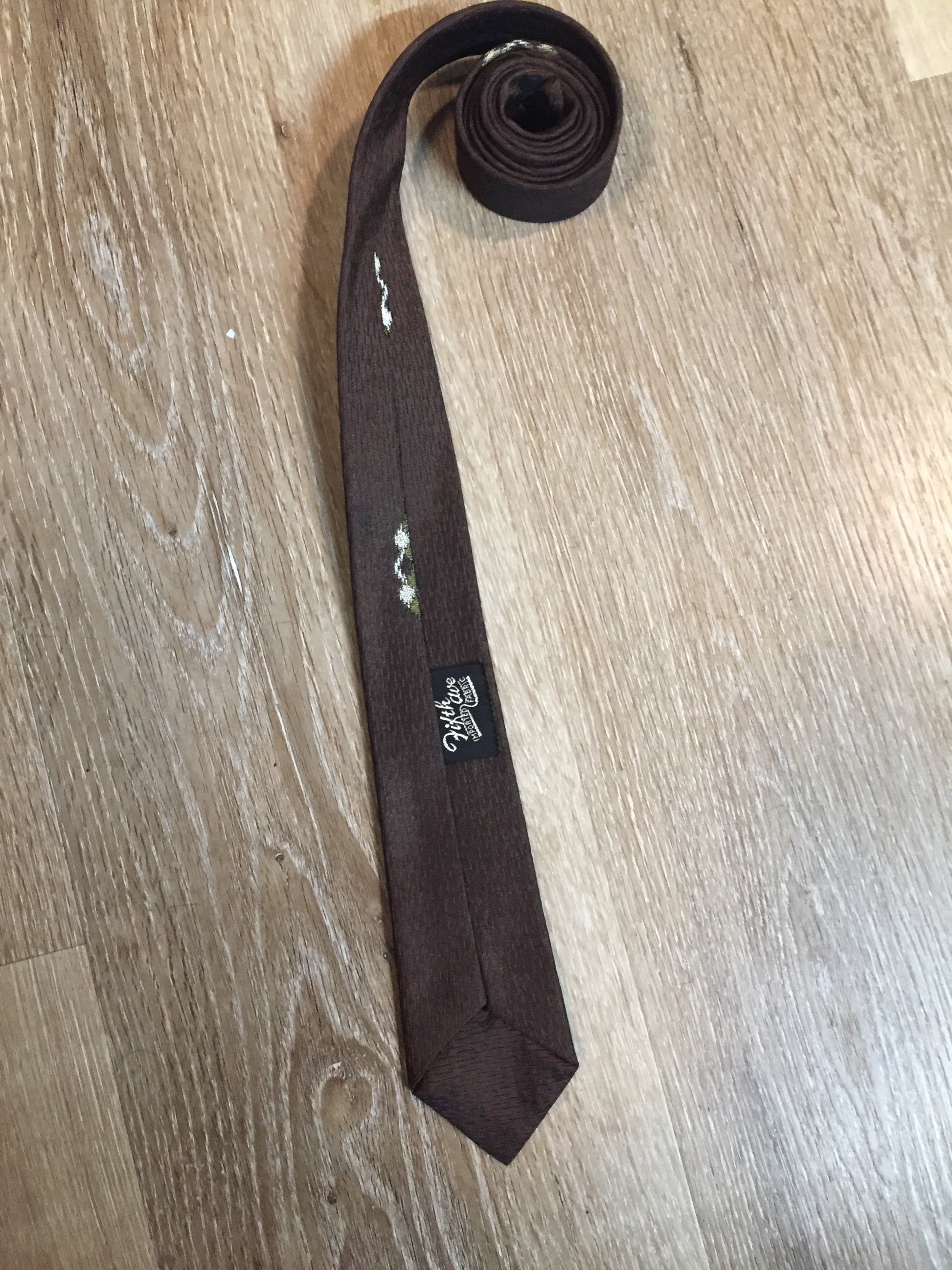 Kingspier Vintage - Fifth Avenue brown tie with white, green and brown diamond motif. Fibres unknown.
Length: 57” 
Width: 2.25” 
This tie is in excellent condition.