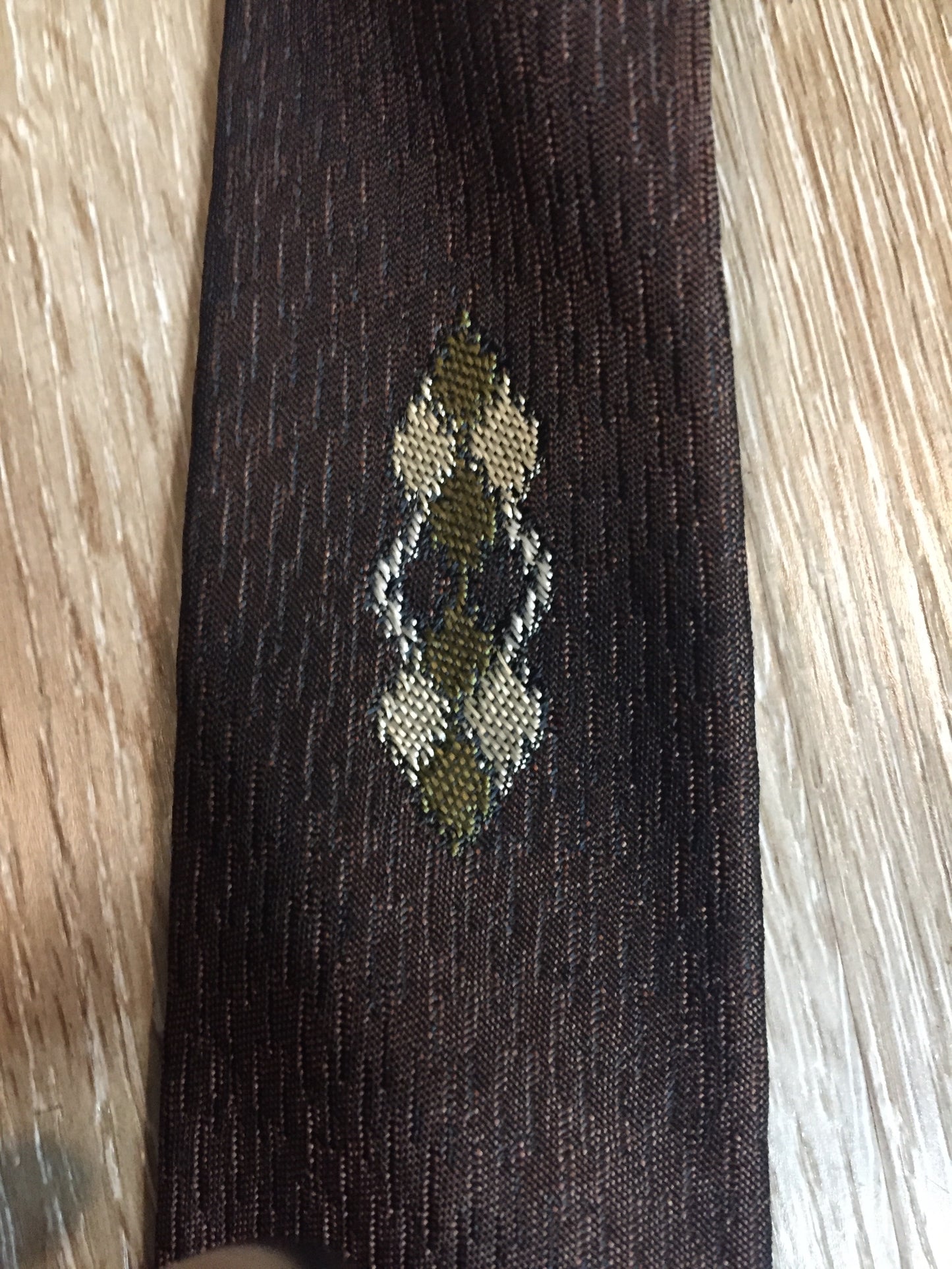 Kingspier Vintage - Fifth Avenue brown tie with white, green and brown diamond motif. Fibres unknown.
Length: 57” 
Width: 2.25” 
This tie is in excellent condition.