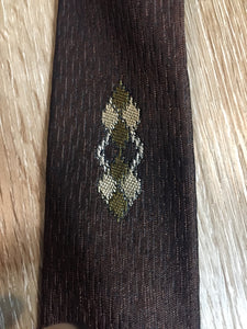 Kingspier Vintage - Fifth Avenue brown tie with white, green and brown diamond motif. Fibres unknown.

Length: 57” 
Width: 2.25” 

This tie is in excellent condition.
