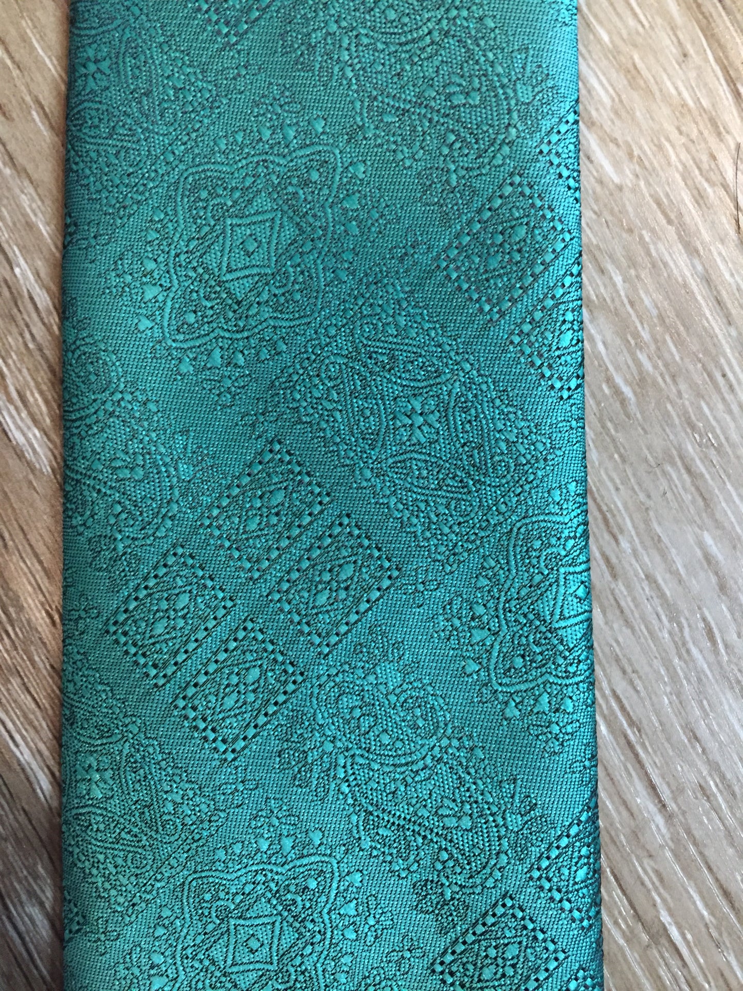 Kingspier Vintage - Vintage blue/green polyester and silk blend tie with subtle paisley pattern. Made in Canada. 
Length: 56.25” 
Width: 3.5” 
This tie is in excellent condition.