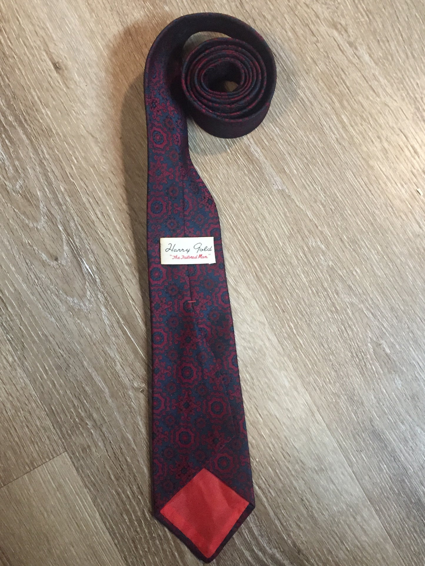 Kingspier Vintage - Harvey Gold tie in red and navy paisley design. Fibres unknown.
Length: 52.5” 
Width: 2.75” 
This tie is in excellent condition.