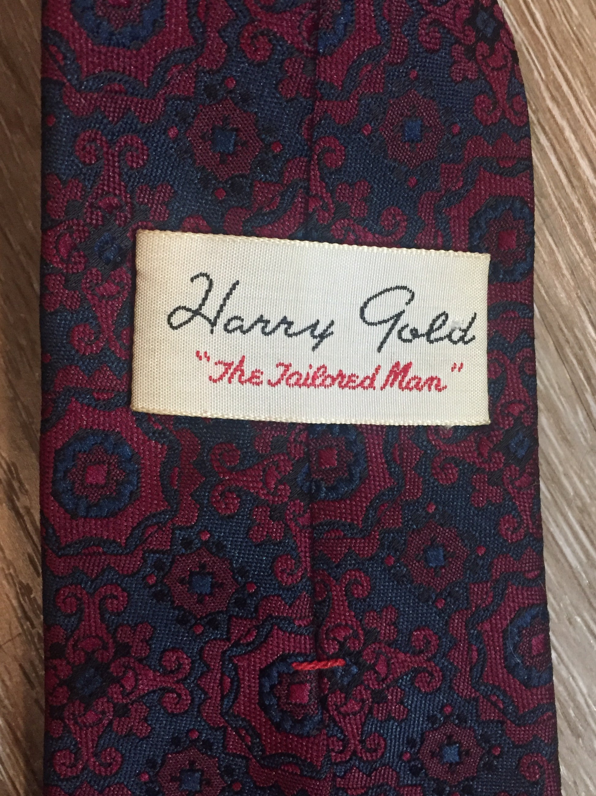 Kingspier Vintage - Harvey Gold tie in red and navy paisley design. Fibres unknown.
Length: 52.5” 
Width: 2.75” 
This tie is in excellent condition.