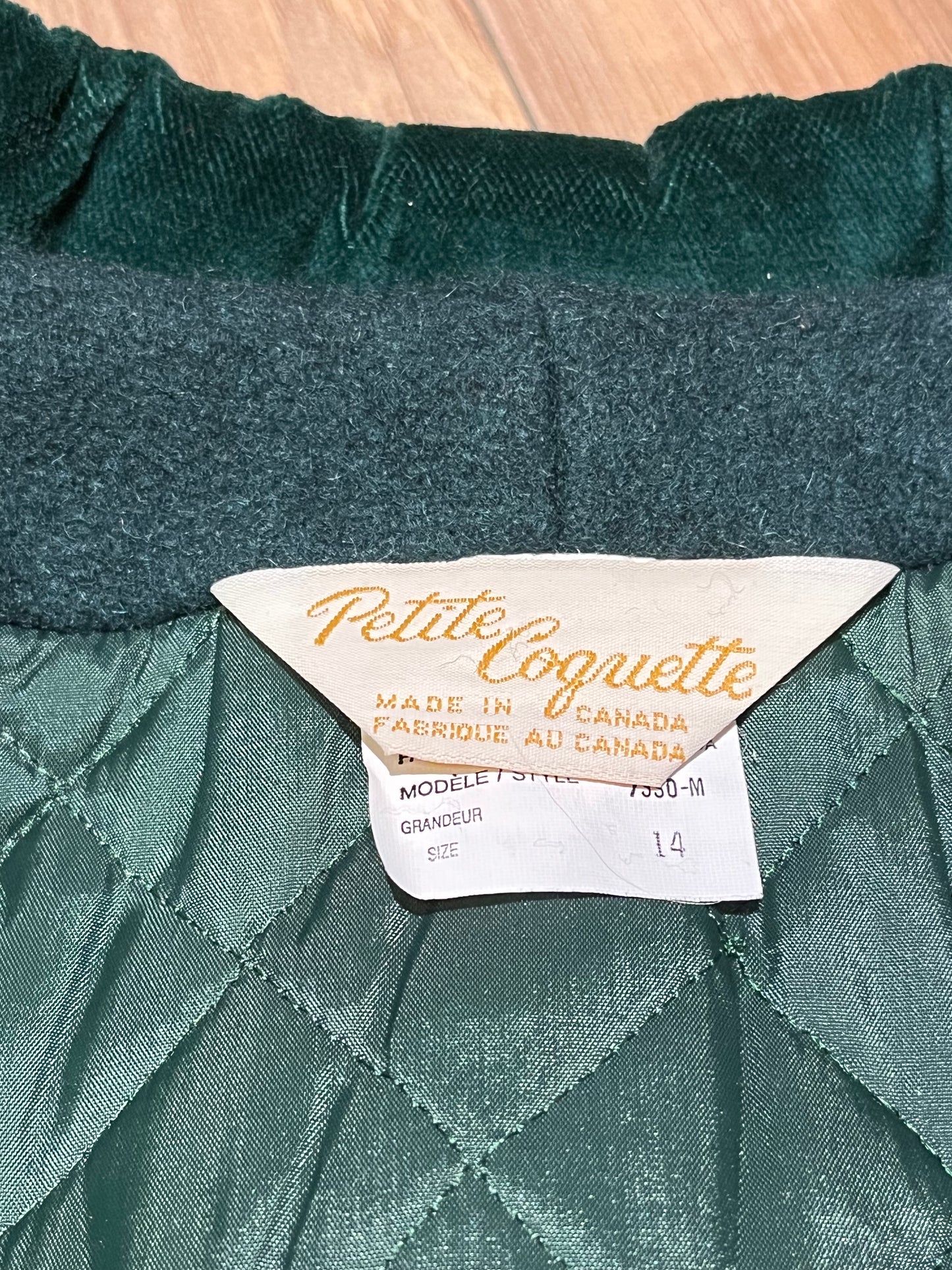 Vintage Coquette dark green wool/ nylon blend coat with button closures, two front pockets, quilted lining, velvet trim and a bow detail in the back.
Made in Canada
Size 14/ Chest 42”