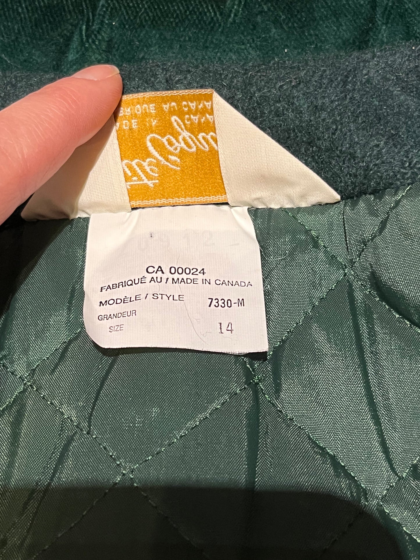 Vintage Coquette dark green wool/ nylon blend coat with button closures, two front pockets, quilted lining, velvet trim and a bow detail in the back.
Made in Canada
Size 14/ Chest 42”