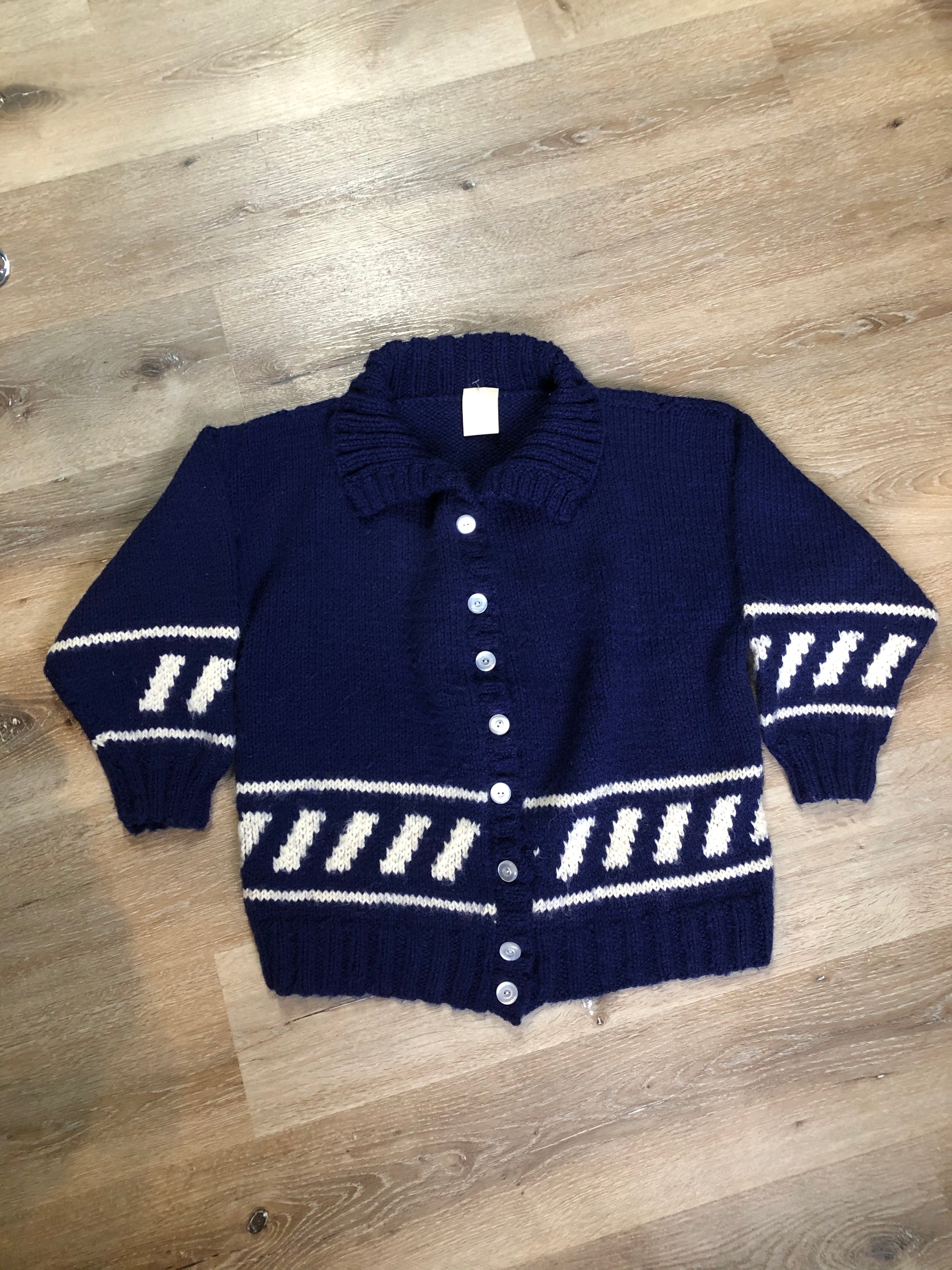Kingspier Vintage - Hand knit royal blue cardigan with white design, collar and button closures. Made in Nova Scotia, Canada. Size large.