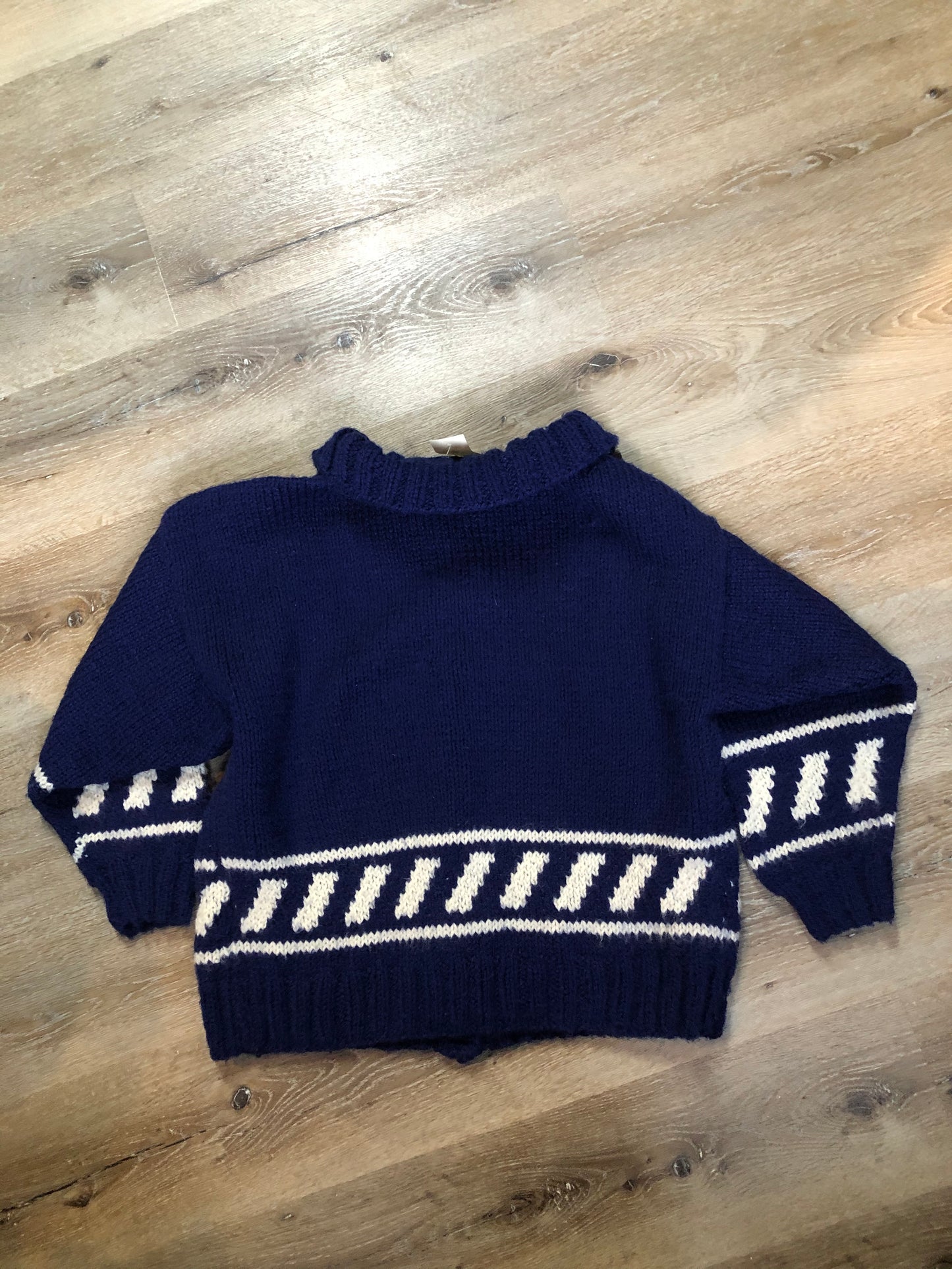 Kingspier Vintage - Hand knit royal blue cardigan with white design, collar and button closures. Made in Nova Scotia, Canada. Size large.