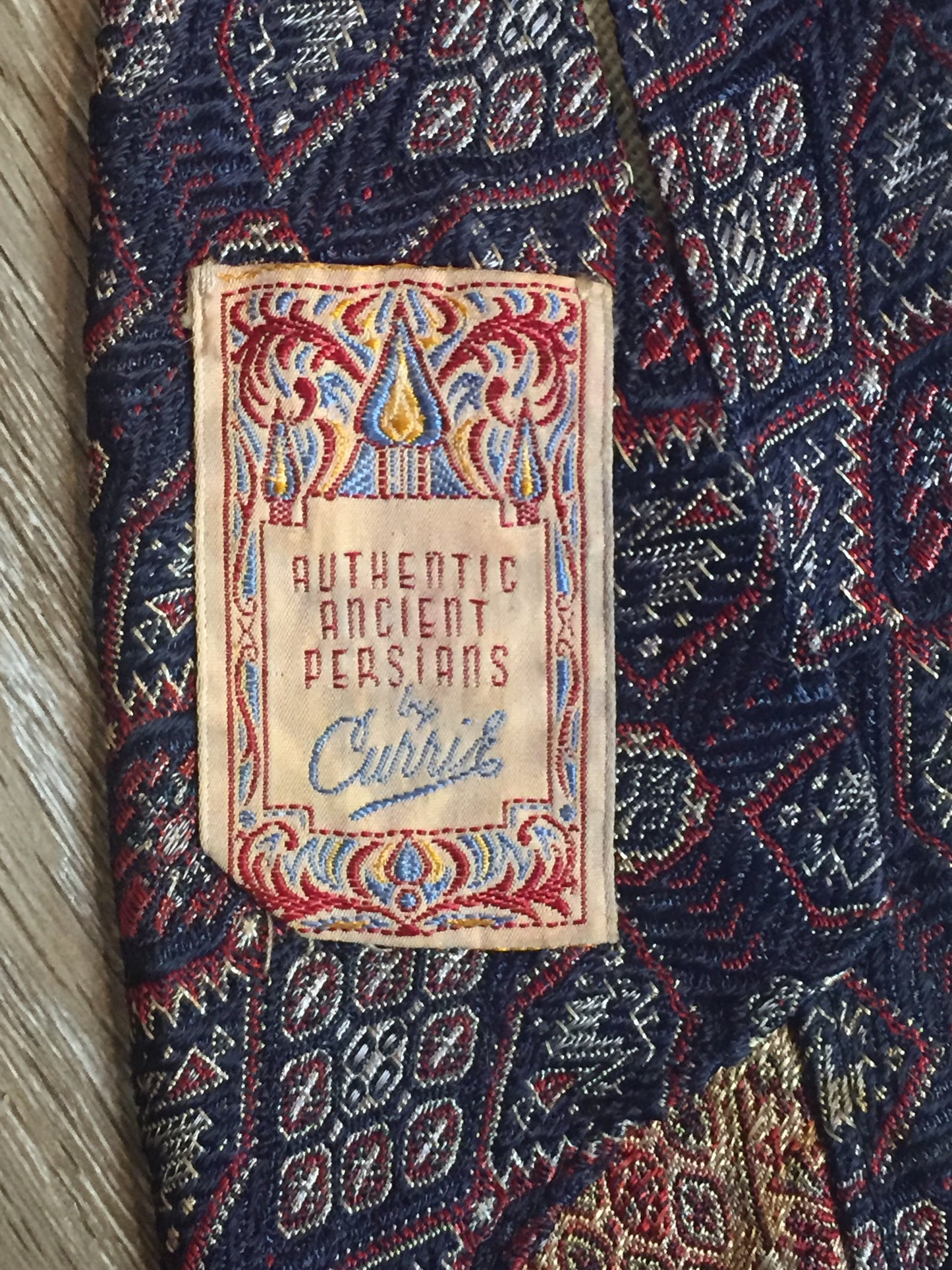 Kingspier Vintage - Currie “Authentic Ancient Persians” with navy, red and cream design. Fibres unknown but feels like sIlk.
Length: 51.5”
Width: 3”
This tie is in great condition with some minor wear.
