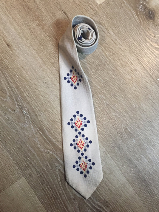 Kingspier Vintage - Arrow tie with silver, red, yellow, and blue design. Made in Canada. Fibres unknown.
Length: 50” 
Width: 3.5” 
This tie is in excellent condition.