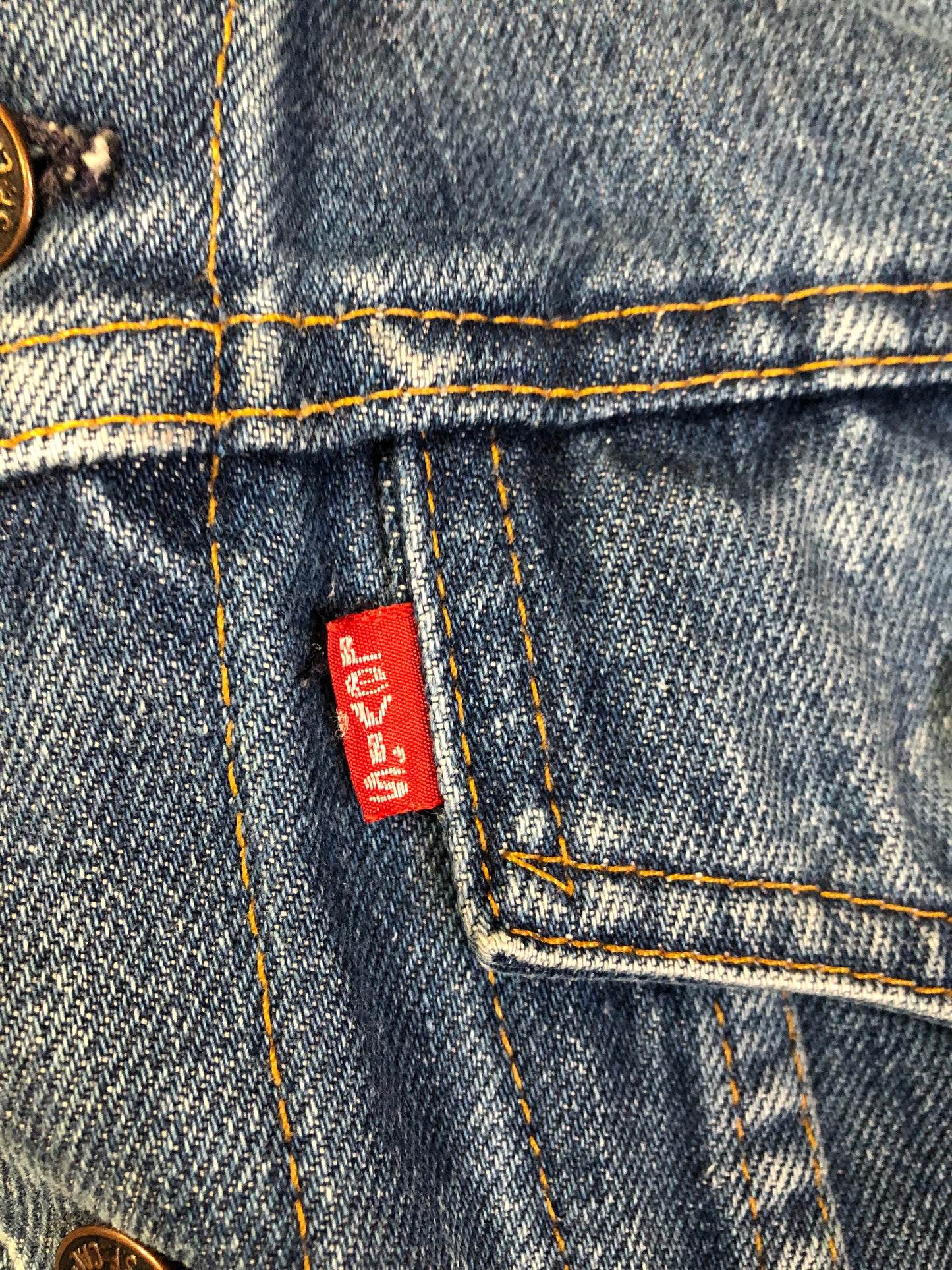 Vintage 1970’s Levi’s medium wash denim trucker jacket with button closures and two flap pockets on the chest. Red Tab, 100% cotton, made in USA, size 18 - Kingspier Vintage