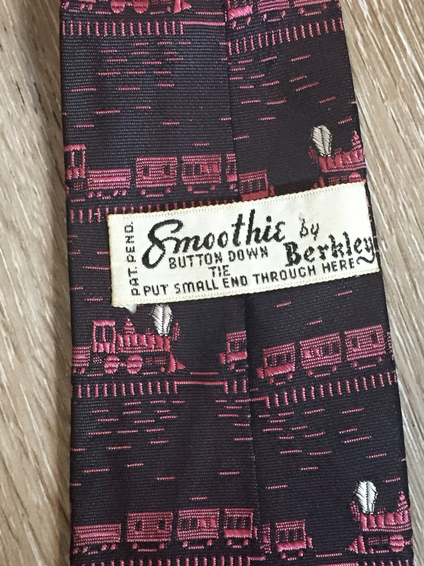 Kingspier Vintage - Berkley “Smoothie” pink and black tie with a train pattern. Fibres unknown.
Length: 58”
Width: 2.5”
This tie is in excellent condition.