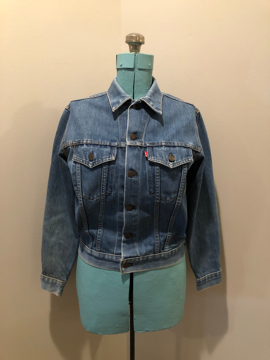 Vintage 1970’s Levi’s medium wash denim trucker jacket with button closures and two flap pockets on the chest.  Red Tab, 100% cotton, made in USA, size 18 - Kingspier Vintage