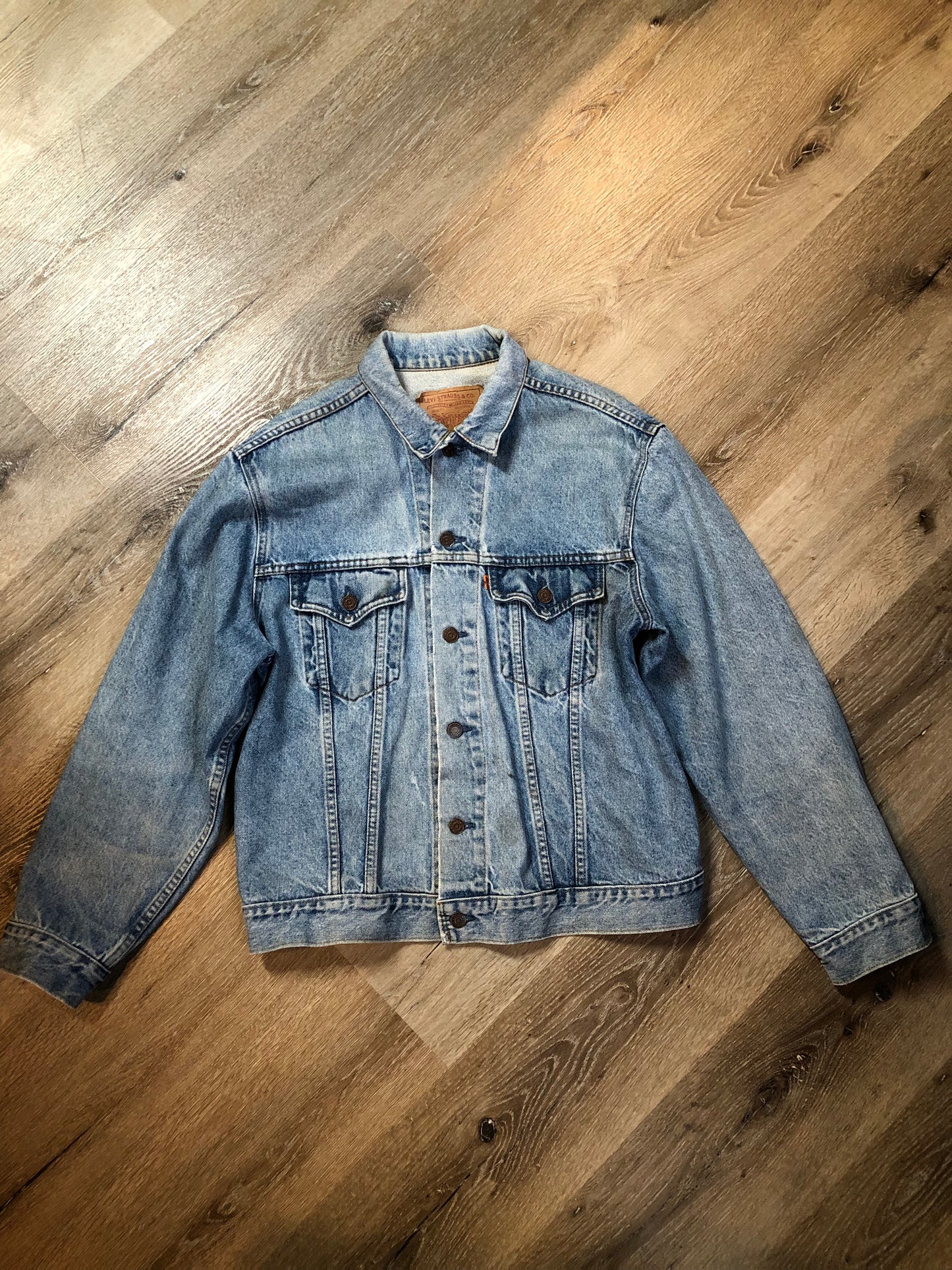 Vintage 1970’s Levi’s light wash denim trucker jacket with button closures and two flap pockets on the chest. Orange Tab, 100% cotton, made in Canada, size 46 - Kingspier Vintage