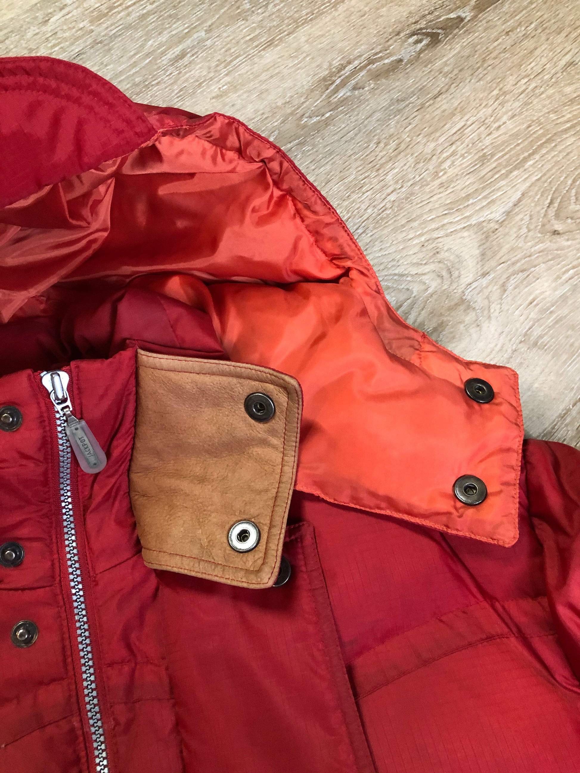 Kingspier Vintage - Vintage Jackpot by Carli Gry red down-fIlled puffer jacket with hood, zipper closure, flap pockets, zip pockets and three inside pockets large enough to fit an included small lightweight backpack,