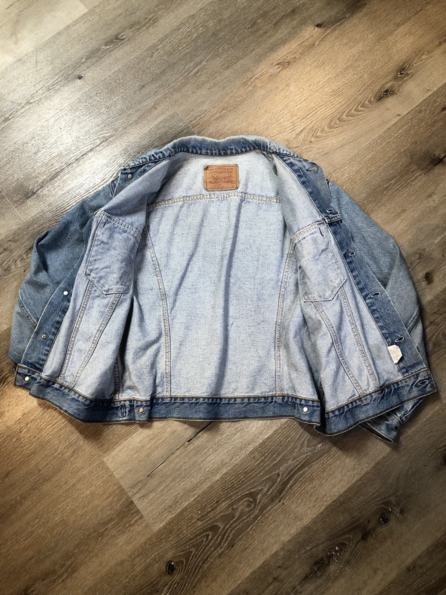 Vintage 1970’s Levi’s light wash denim trucker jacket with button closures and two flap pockets on the chest. Orange Tab, 100% cotton, made in Canada, size 46 - Kingspier Vintage