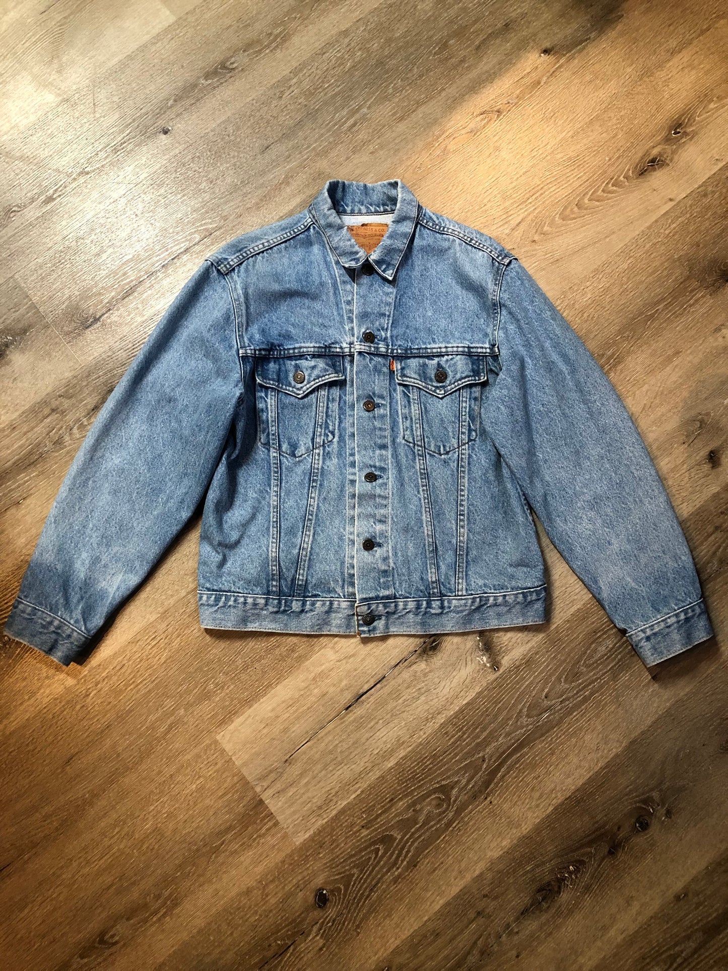 Vintage 1970’s Levi’s light wash denim trucker jacket with button closures and two flap pockets on the chest. Orange Tab, 100% cotton, made in Canada, size 40 - Kingspier Vintage
