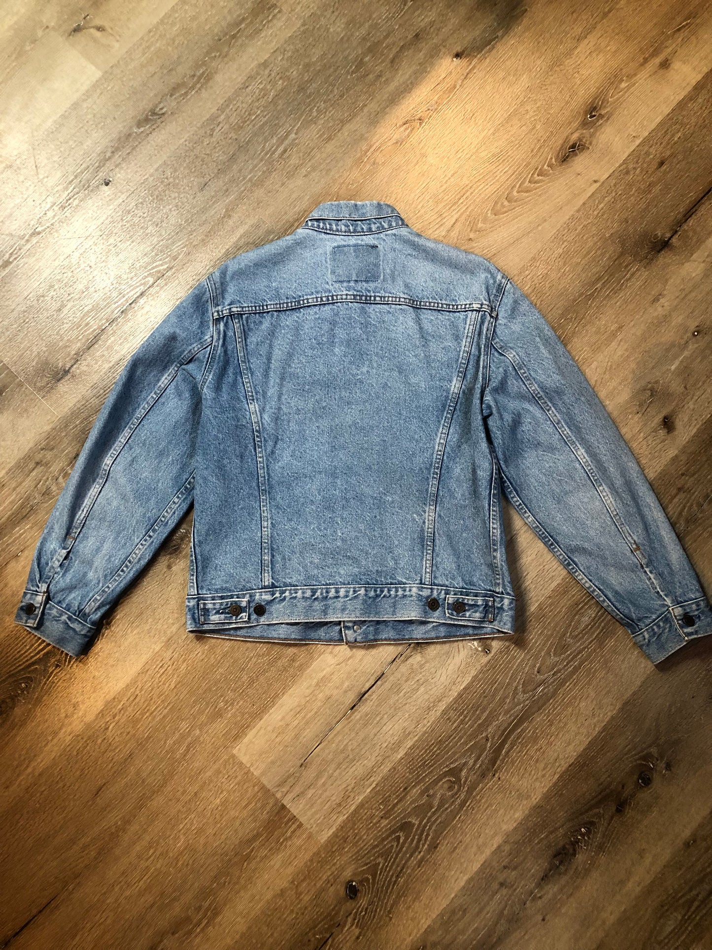 Vintage 1970’s Levi’s light wash denim trucker jacket with button closures and two flap pockets on the chest. Orange Tab, 100% cotton, made in Canada, size 40 - Kingspier Vintage