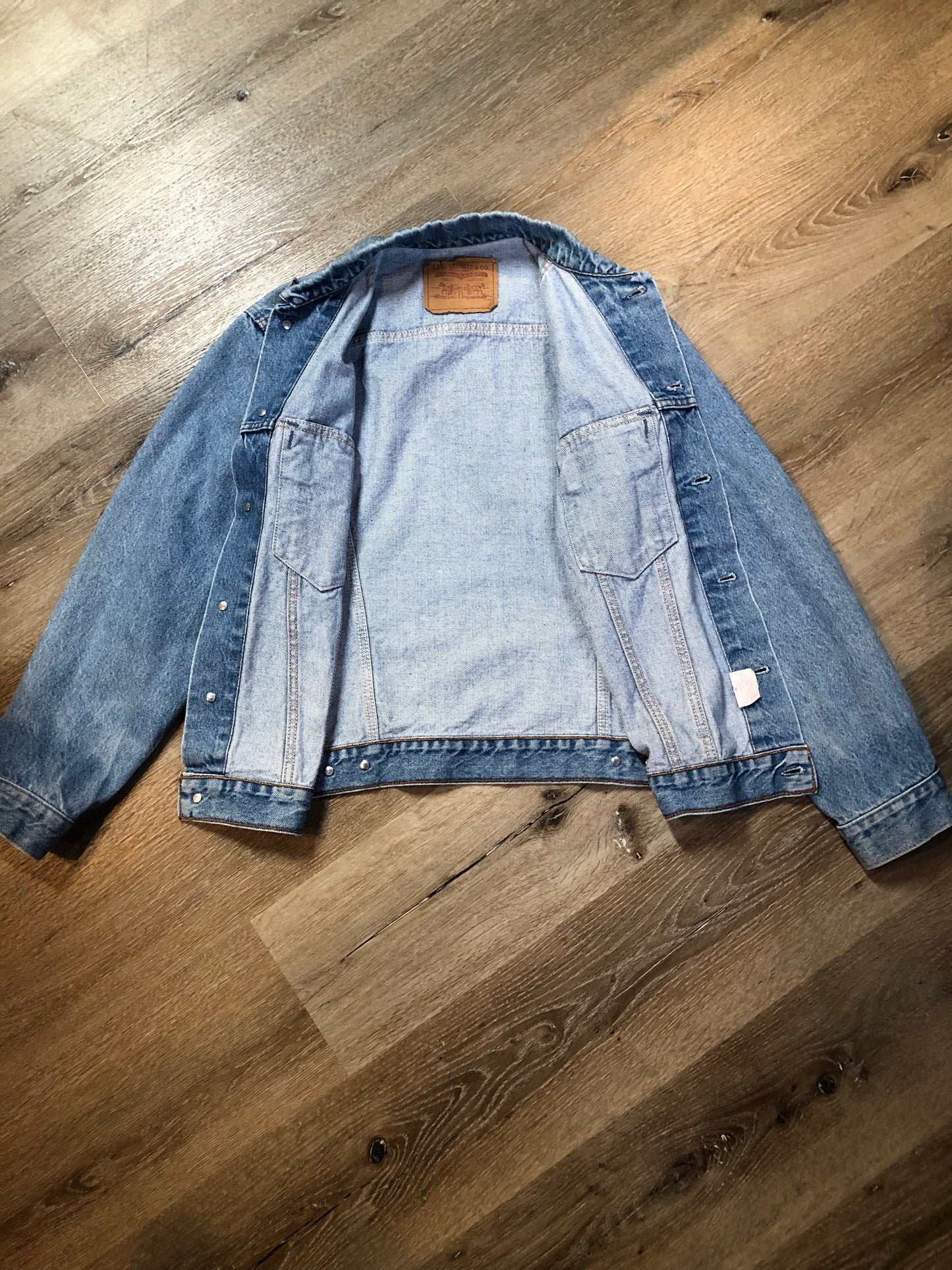 Vintage 1970’s Levi’s light wash denim trucker jacket with button closures and two flap pockets on the chest. Orange Tab, 100% cotton, made in Canada, size 40 - Kingspier Vintage