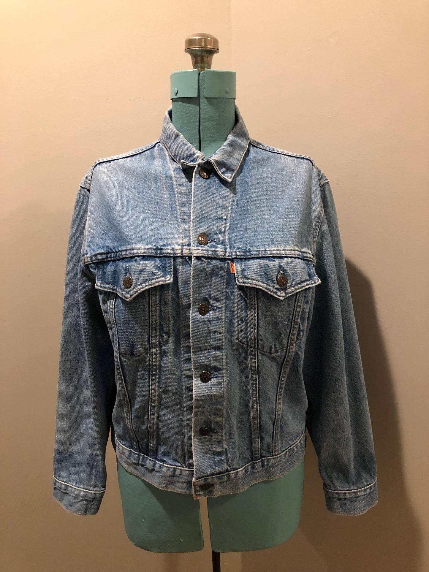 Vintage 1970’s Levi’s light wash denim trucker jacket with button closures and two flap pockets on the chest. Orange Tab, 100% cotton, made in Canada, size 40 - Kingspier Vintage