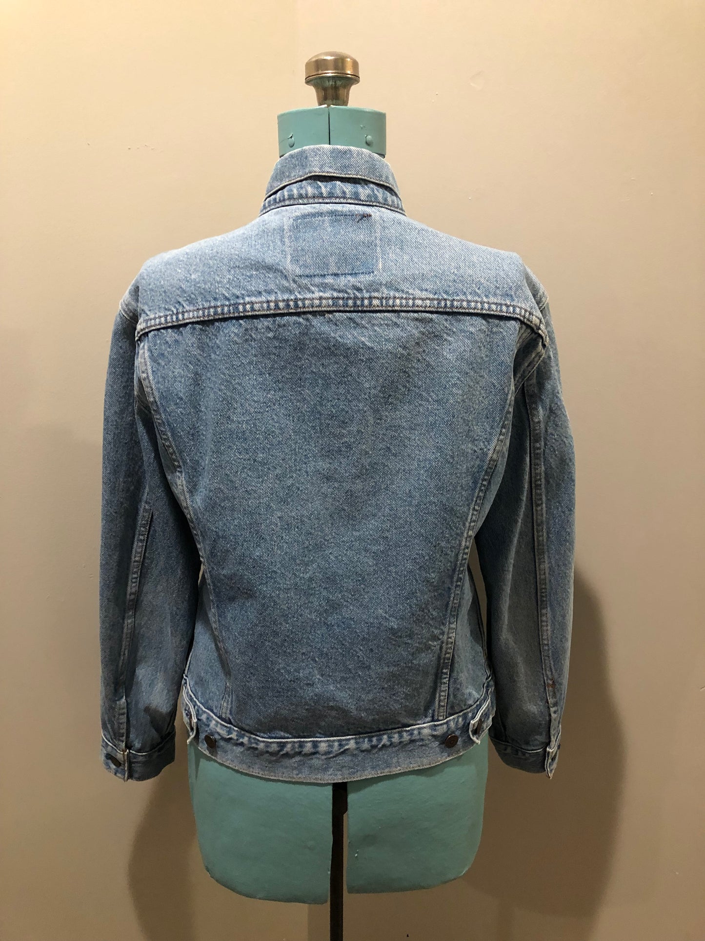 Vintage 1970’s Levi’s light wash denim trucker jacket with button closures and two flap pockets on the chest. Orange Tab, 100% cotton, made in Canada, size 40 - Kingspier Vintage