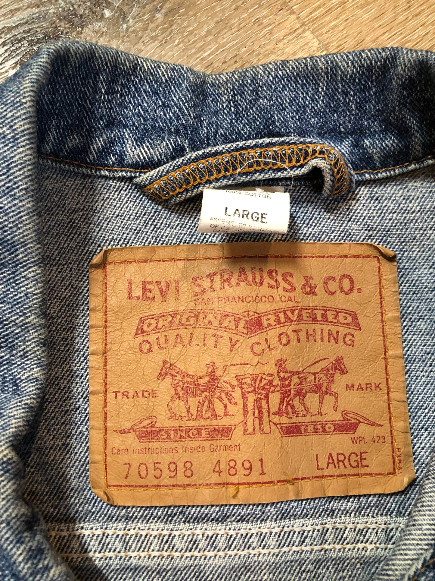 Vintage 1980’s Levi’s medium wash denim trucker jacket with button closures, two flap pockets on the chest, two side pockets and two inside pockets. Red Tab, 100% cotton, size large -Kingspier Vintage