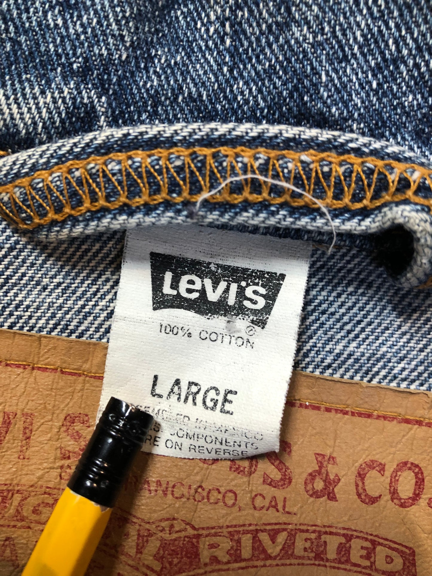 Vintage 1980’s Levi’s medium wash denim trucker jacket with button closures, two flap pockets on the chest, two side pockets and two inside pockets. Red Tab, 100% cotton, size large -Kingspier Vintage