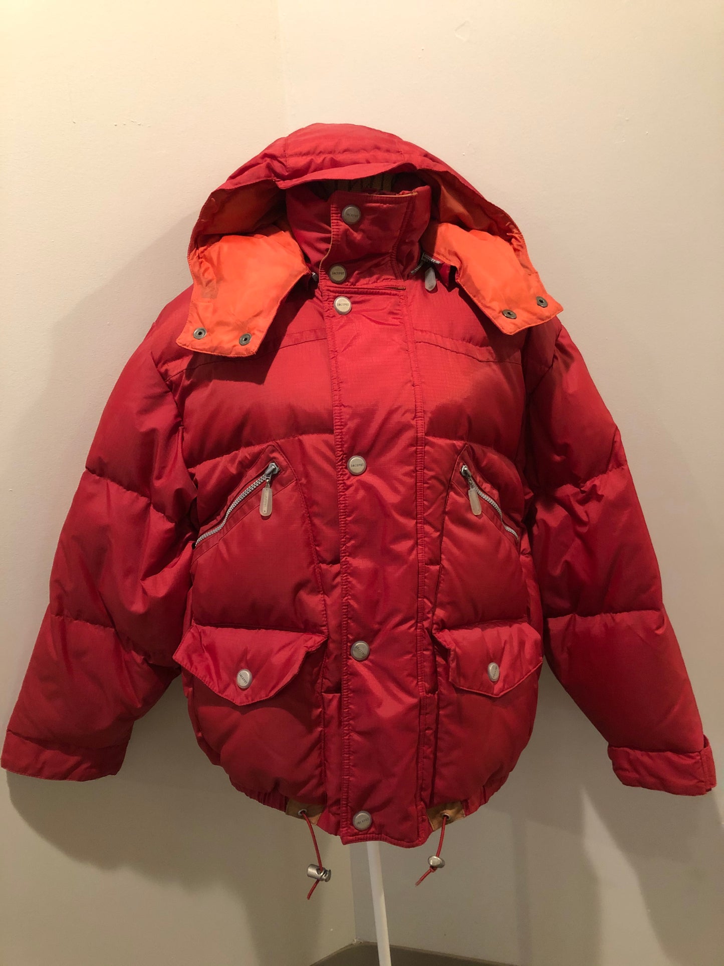Kingspier Vintage - Vintage Jackpot by Carli Gry red down-fIlled puffer jacket with hood, zipper closure, flap pockets, zip pockets and three inside pockets large enough to fit an included small lightweight backpack,