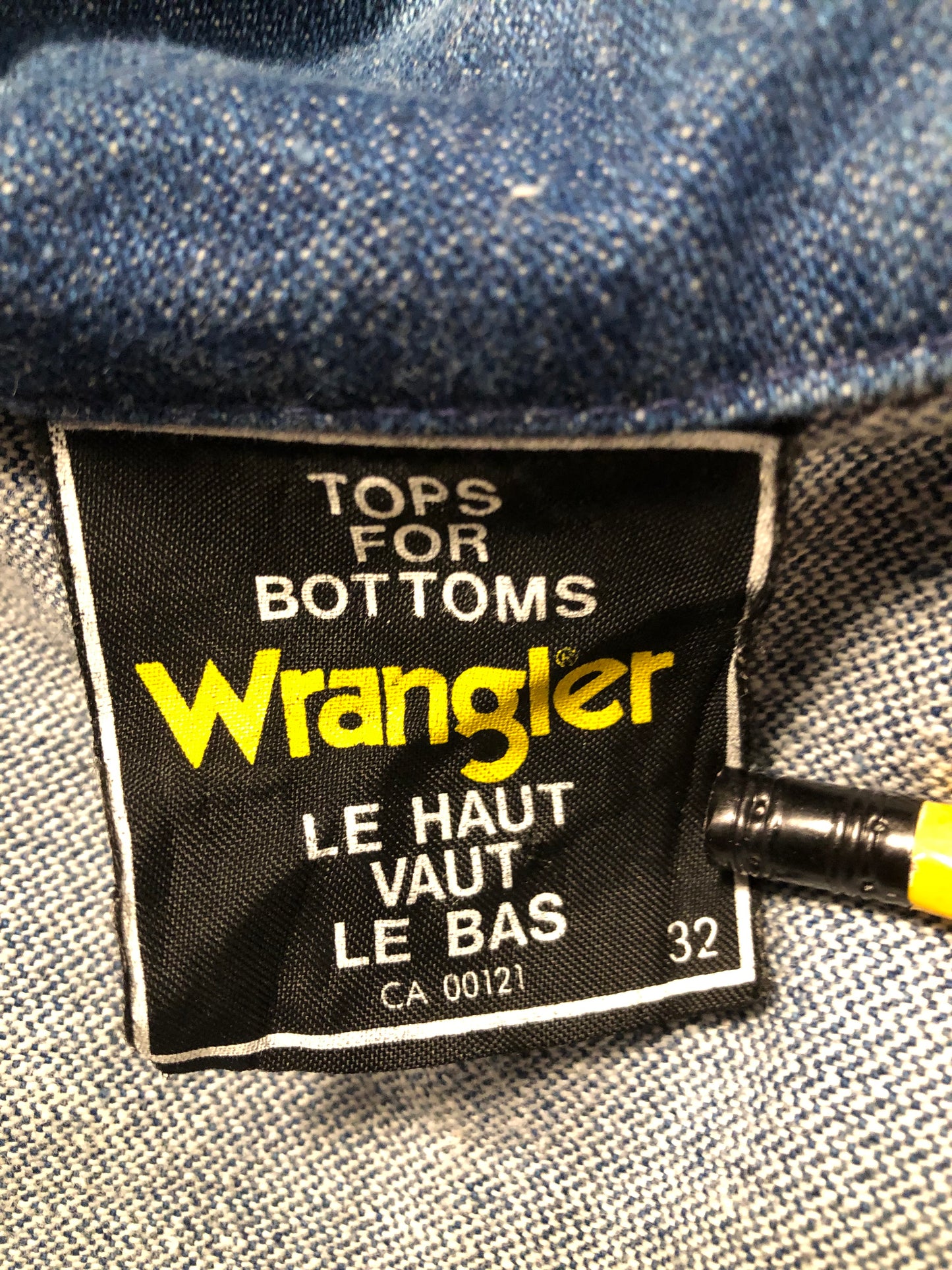 Vintage Wrangler medium wash denim jacket with button closures, two flap pockets on the chest and two hand warmer pockets in the front. 100% cotton, made in Canada, size 32 - Kingspier Vintage
