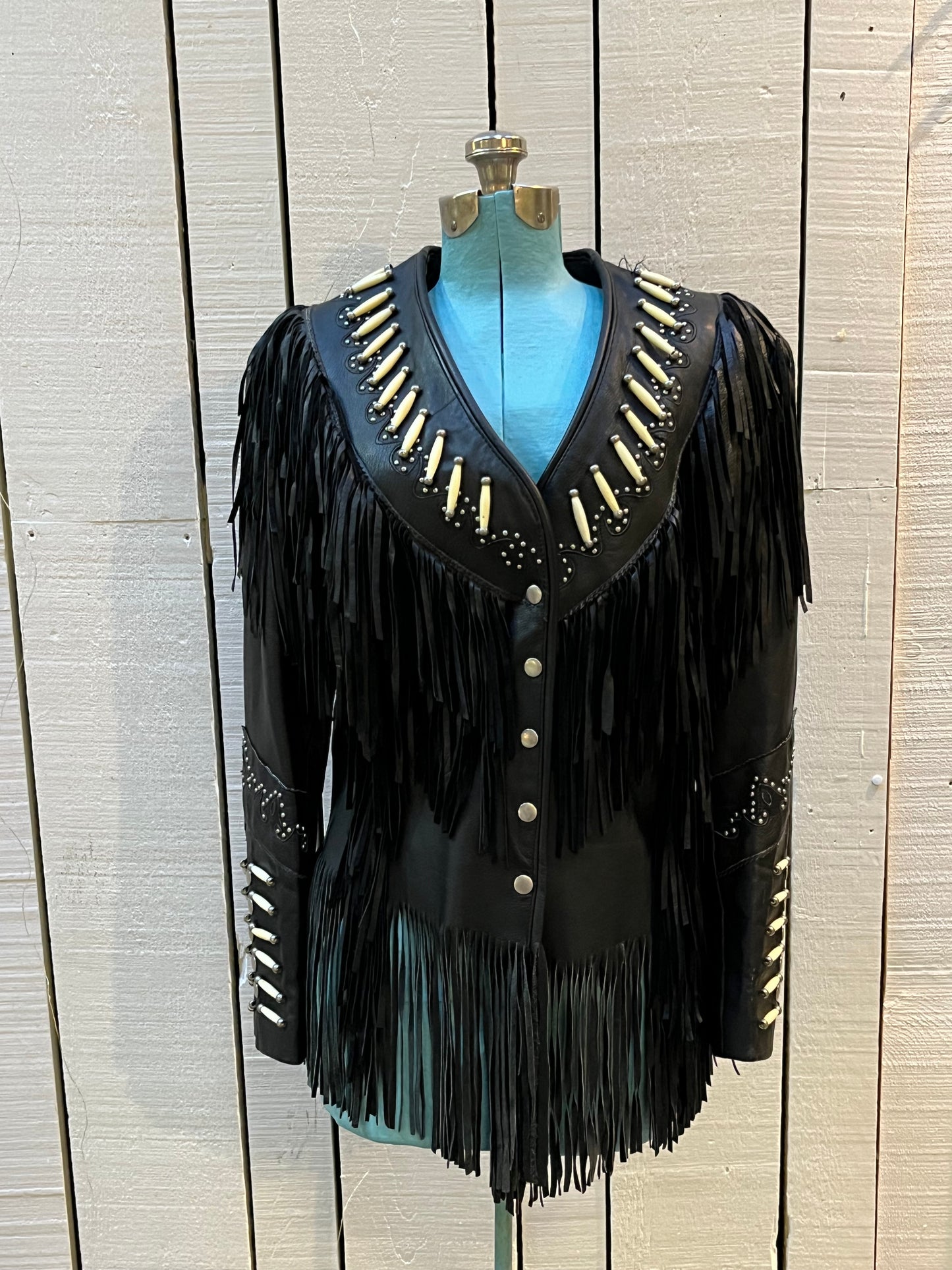Rare authentic vintage leather jacket with fringe once owned by June Carter. Consigned by a former member of Johnny Cash’s band from 1987-1990.
The Western World by Shaf jacket features snap closures, leather fringe, beaded and stud details.
Size Medium