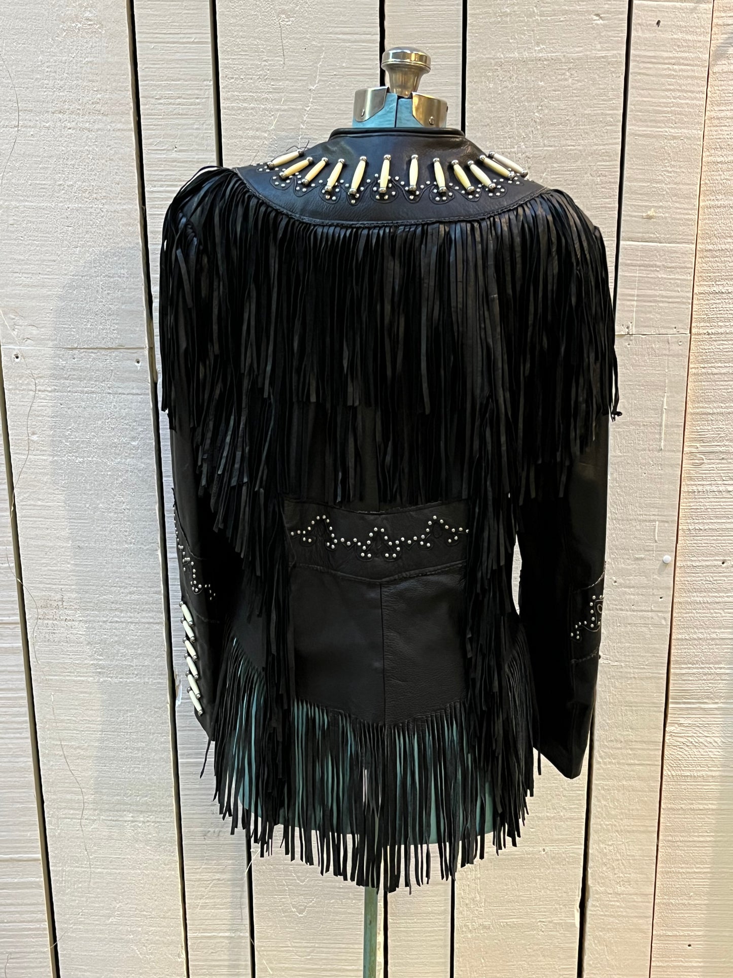 Rare authentic vintage leather jacket with fringe once owned by June Carter. Consigned by a former member of Johnny Cash’s band from 1987-1990.
The Western World by Shaf jacket features snap closures, leather fringe, beaded and stud details.
Size Medium