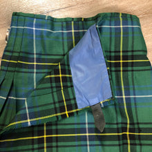Load image into Gallery viewer, Kingspier Vintage - Green, blue, black, yellow and white plaid/ tartan kilt with leather straps on each side to adjust size. Kilt is partially lined on the inside. Fibres unknown.
