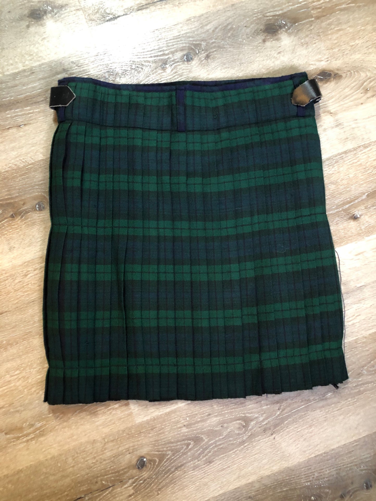 Kingspier Vintage - Black Watch tartan kilt with leather straps on each side to adjust size and fringed top skirt. Kilt is partially lined. Fibres unknown.