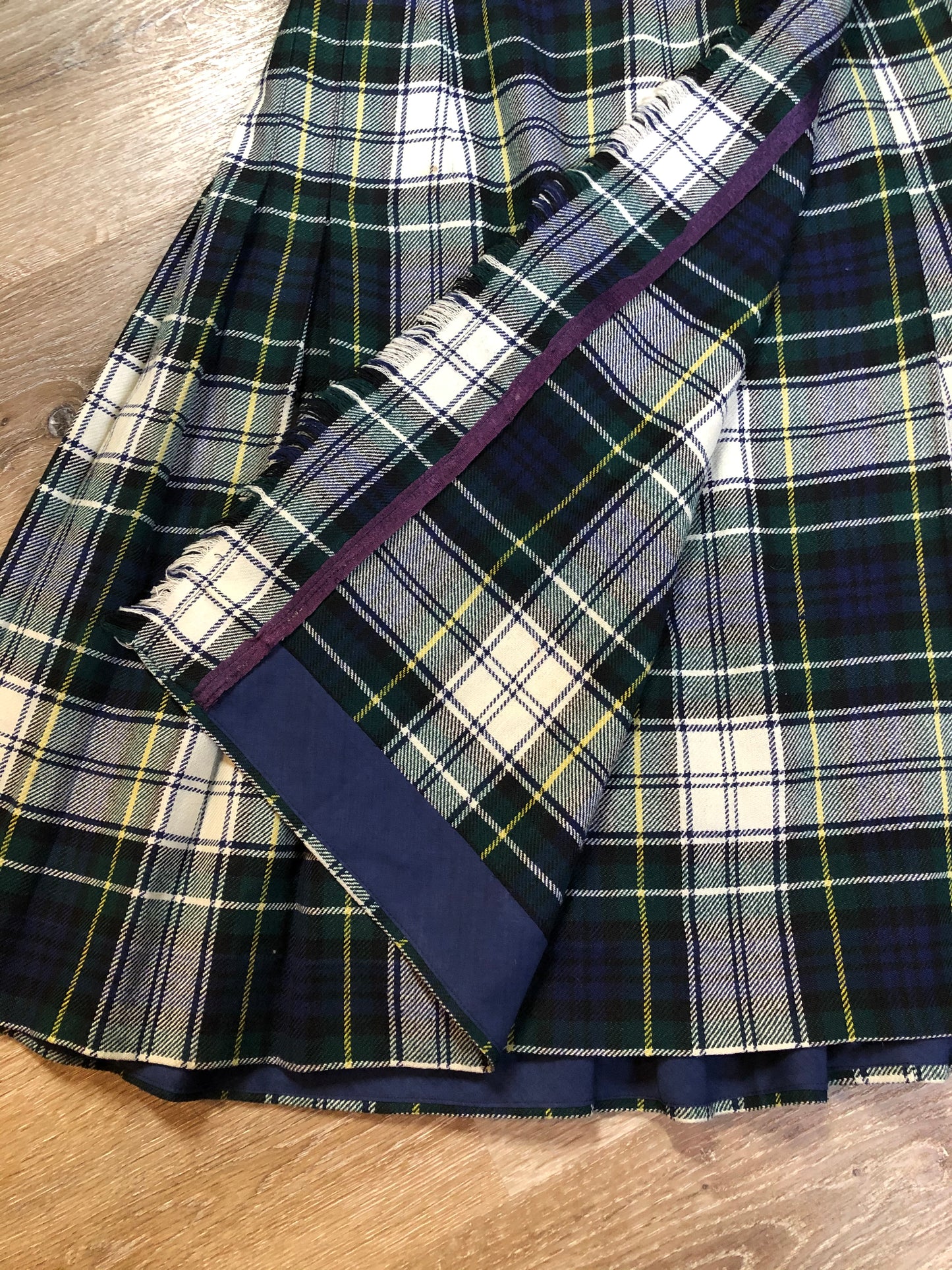 Kingspier Vintage - Vintage RJ McCarthy LTD white, green, blue, yellow and black plaid wool kilt with adjustable leather straps and a fringed over skirt. Made in Canada. Size 16.