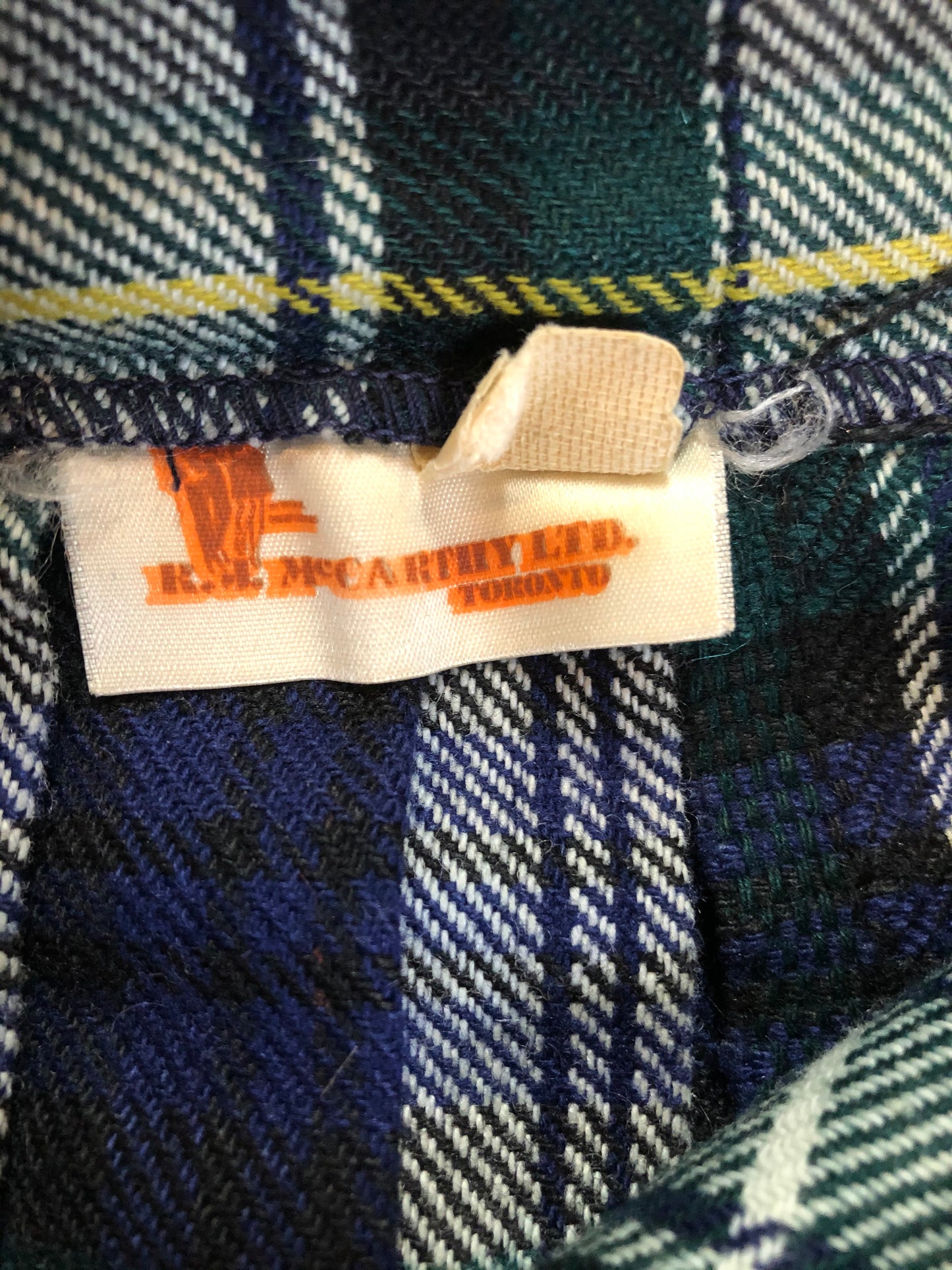 Kingspier Vintage - Vintage RJ McCarthy LTD white, green, blue, yellow and black plaid wool kilt with adjustable leather straps and a fringed over skirt. Made in Canada. Size 16.