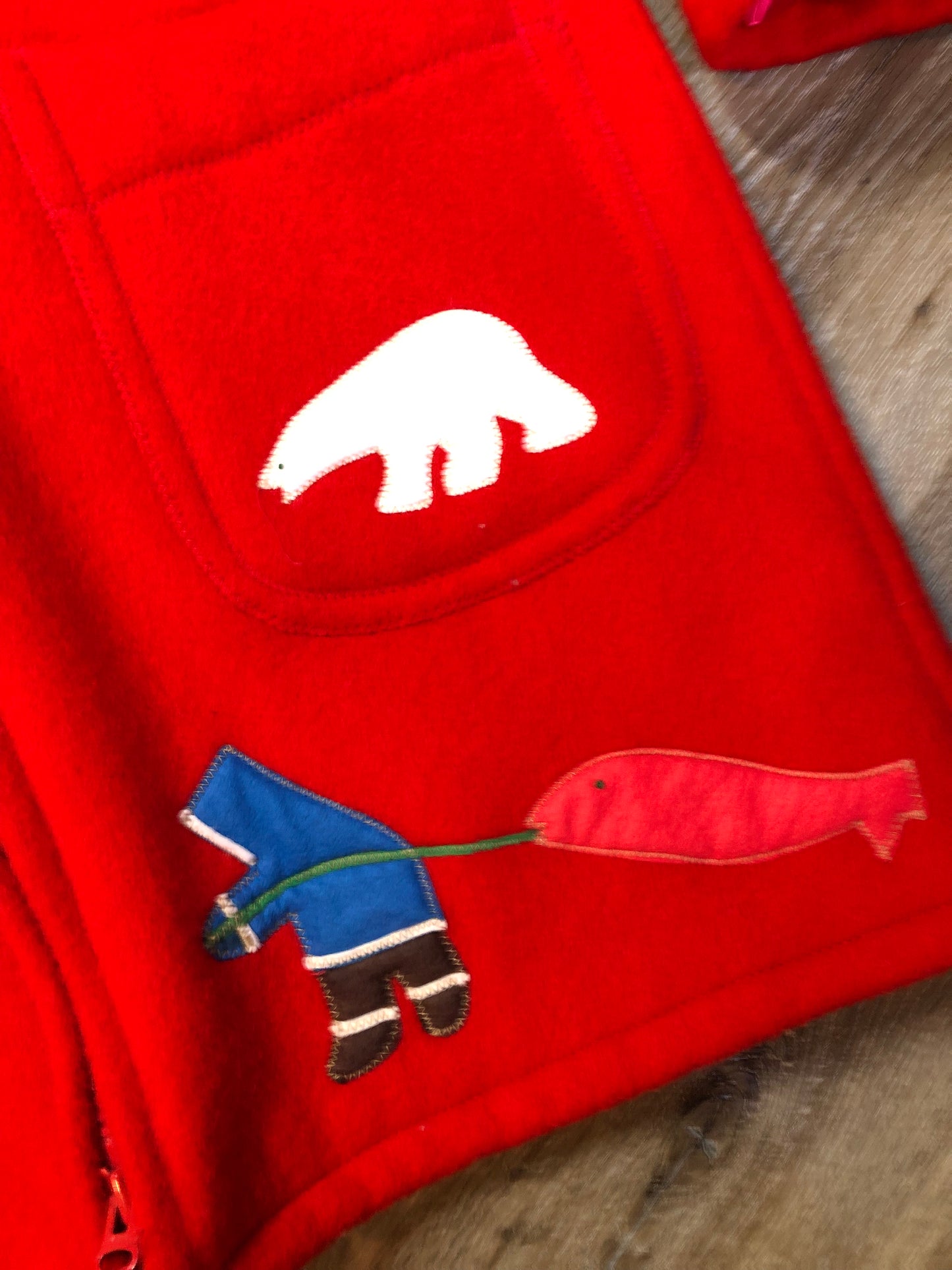 Vintage Inuvik Parka Enterprise red 100% pure wool northern parka. This parka features a cotton/ polyester blend storm shell with embroidered details, a fur trimmed hood, zipper closure, patch pockets, satin lining and a northern fishing design in felt applique. Made in northern Canada. Size 46 - Kingspier Vintage