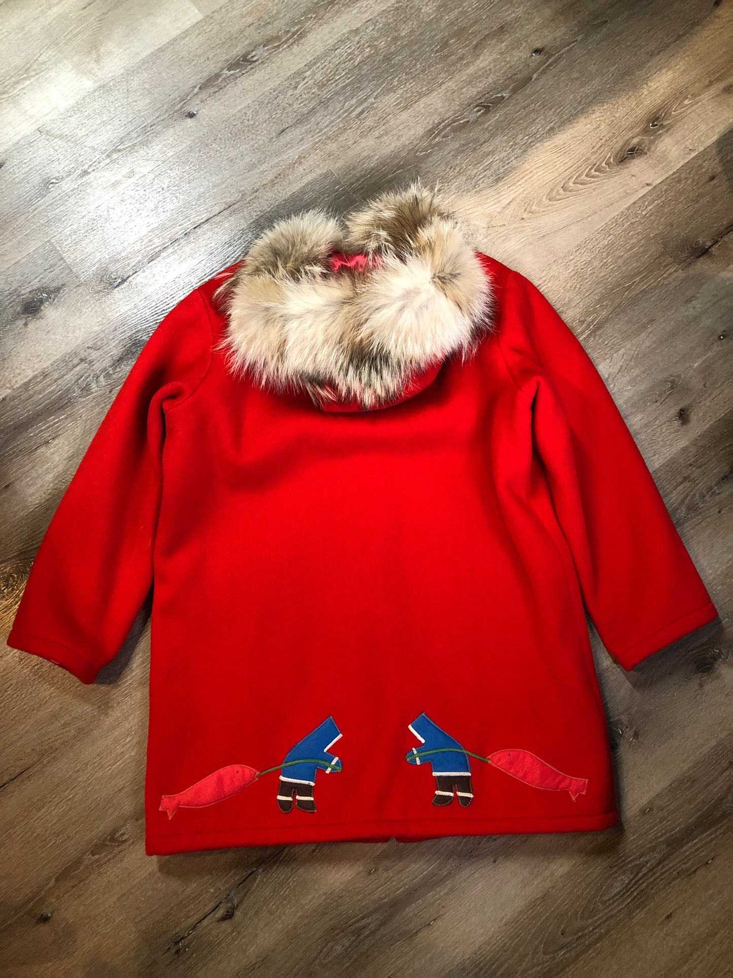 Vintage Inuvik Parka Enterprise red 100% pure wool northern parka. This parka features a cotton/ polyester blend storm shell with embroidered details, a fur trimmed hood, zipper closure, patch pockets, satin lining and a northern fishing design in felt applique. Made in northern Canada. Size 46 - Kingspier Vintage