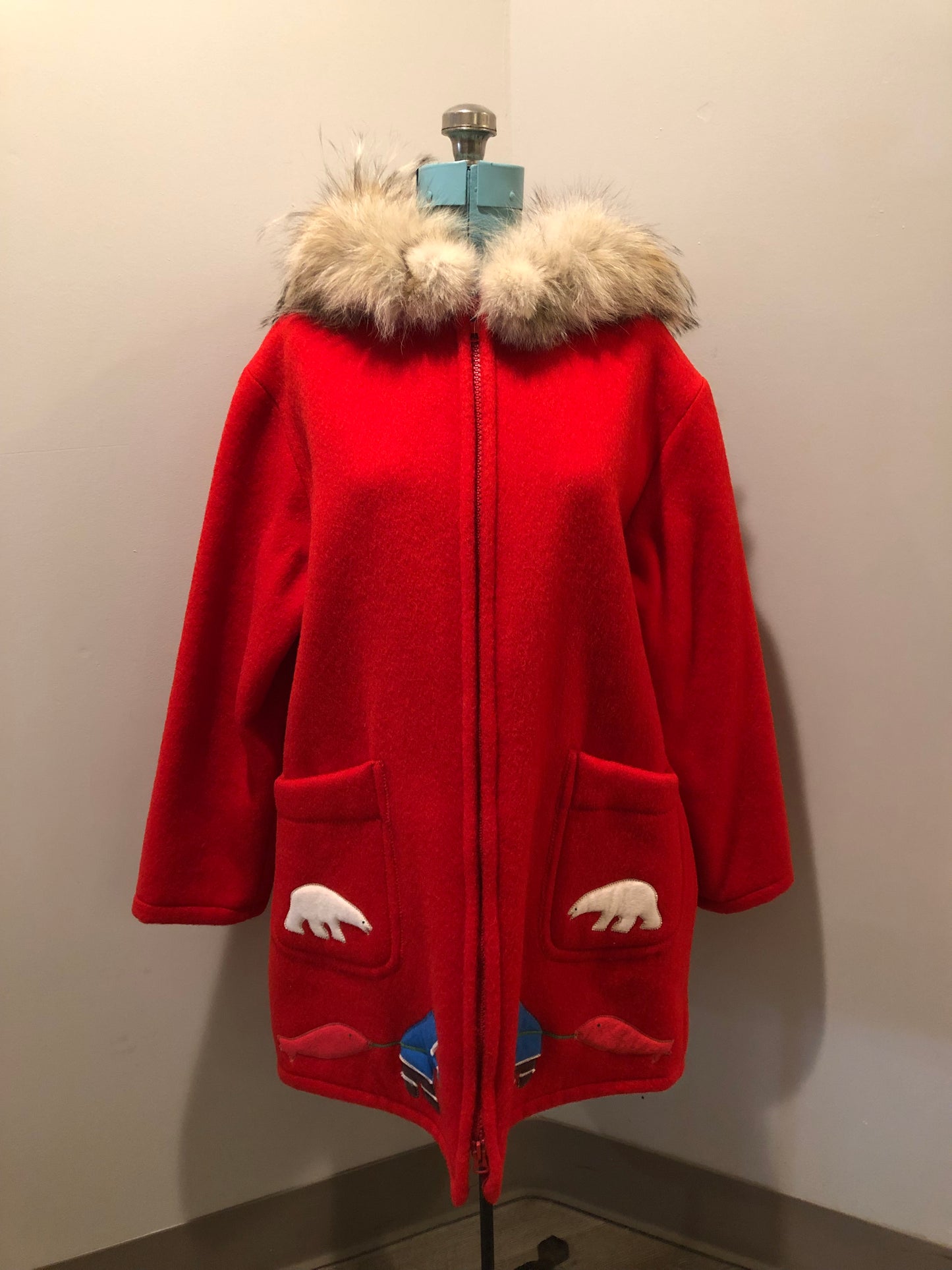 Vintage Inuvik Parka Enterprise red 100% pure wool northern parka. This parka features a cotton/ polyester blend storm shell with embroidered details, a fur trimmed hood, zipper closure, patch pockets, satin lining and a northern fishing design in felt applique. Made in northern Canada. Size 46 - Kingspier Vintage