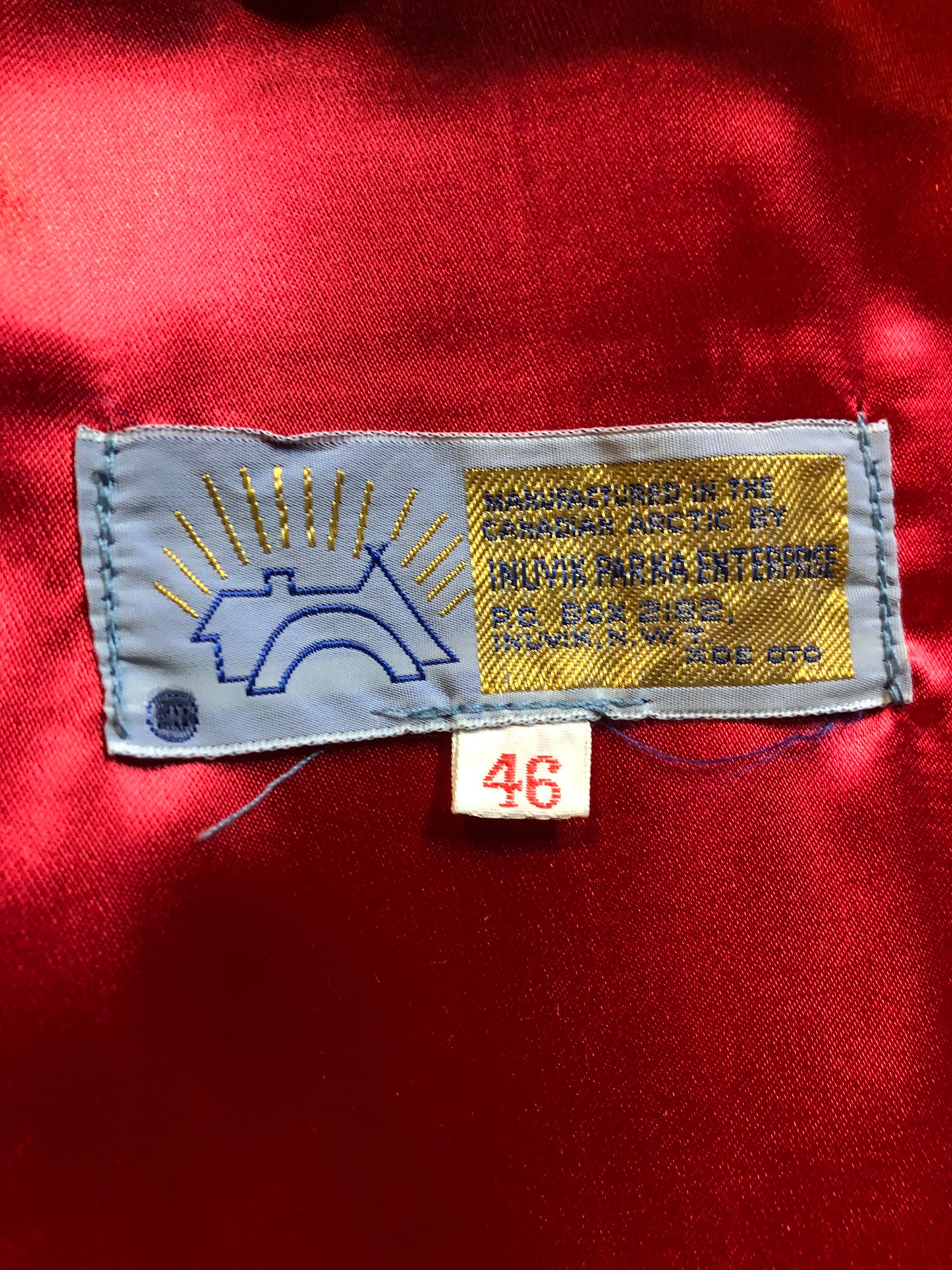 Vintage Inuvik Parka Enterprise red 100% pure wool northern parka. This parka features a cotton/ polyester blend storm shell with embroidered details, a fur trimmed hood, zipper closure, patch pockets, satin lining and a northern fishing design in felt applique. Made in northern Canada. Size 46 - Kingspier Vintage