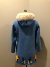 Load image into Gallery viewer, Vintage Hudson’s Bay Company 100% pure wool northern parka in sky blue.  This parka features a fur trimmed hood, zipper closure, patch pockets, purple satin lining and a drumming and dance design in felt applique. Made in Canada by the Inuvik Parka Company - Kingspier Vintage
