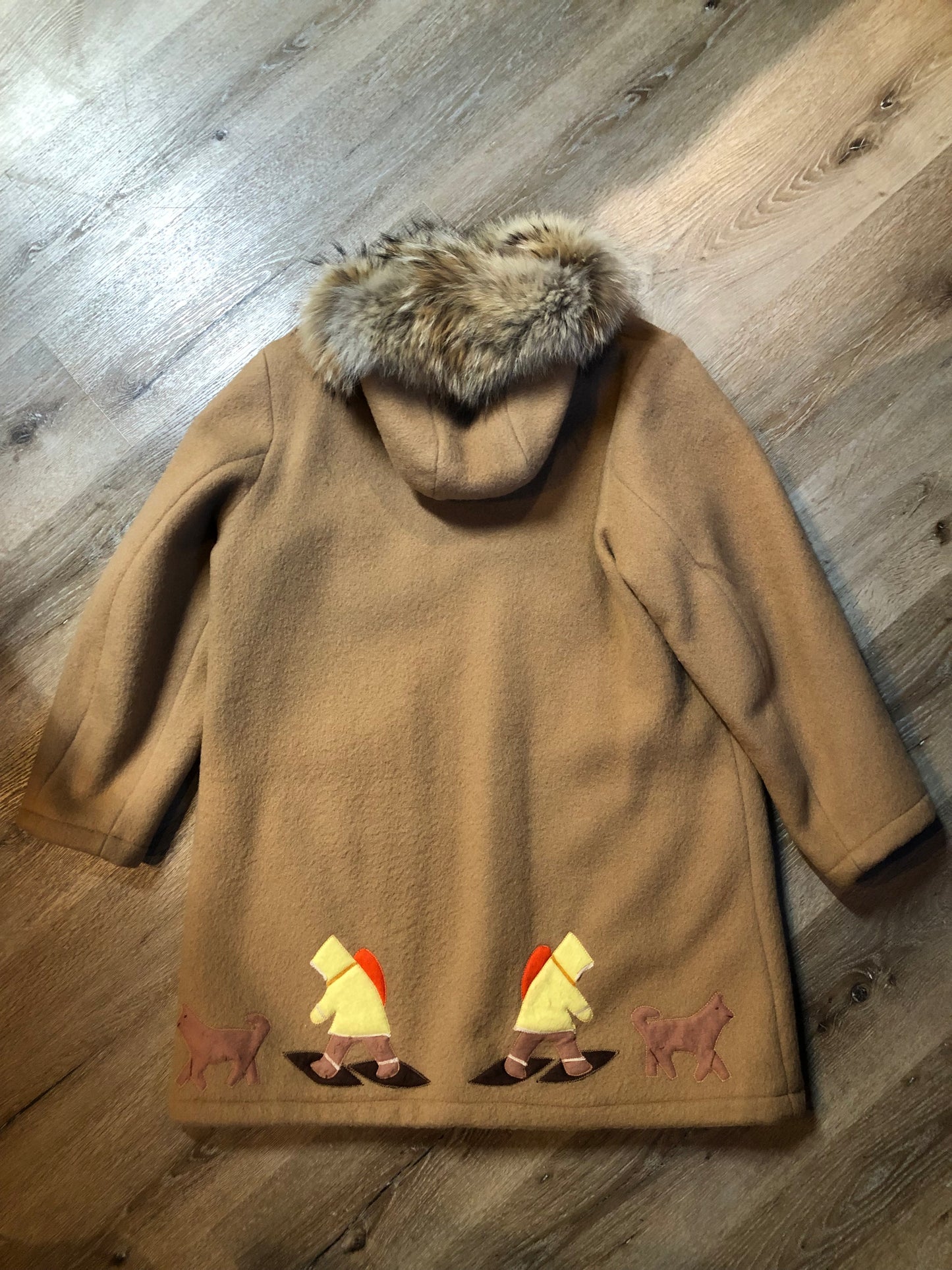 Vintage Inuvik Sewing Company brown 100% pure wool parka. This parka features a cotton/ polyester blend storm shell with embroidered details, a fur trimmed hood, zipper closure, patch pockets, satin lining and a snowshoeing design in felt applique. Made in northern Canada - Kingspier Vintage