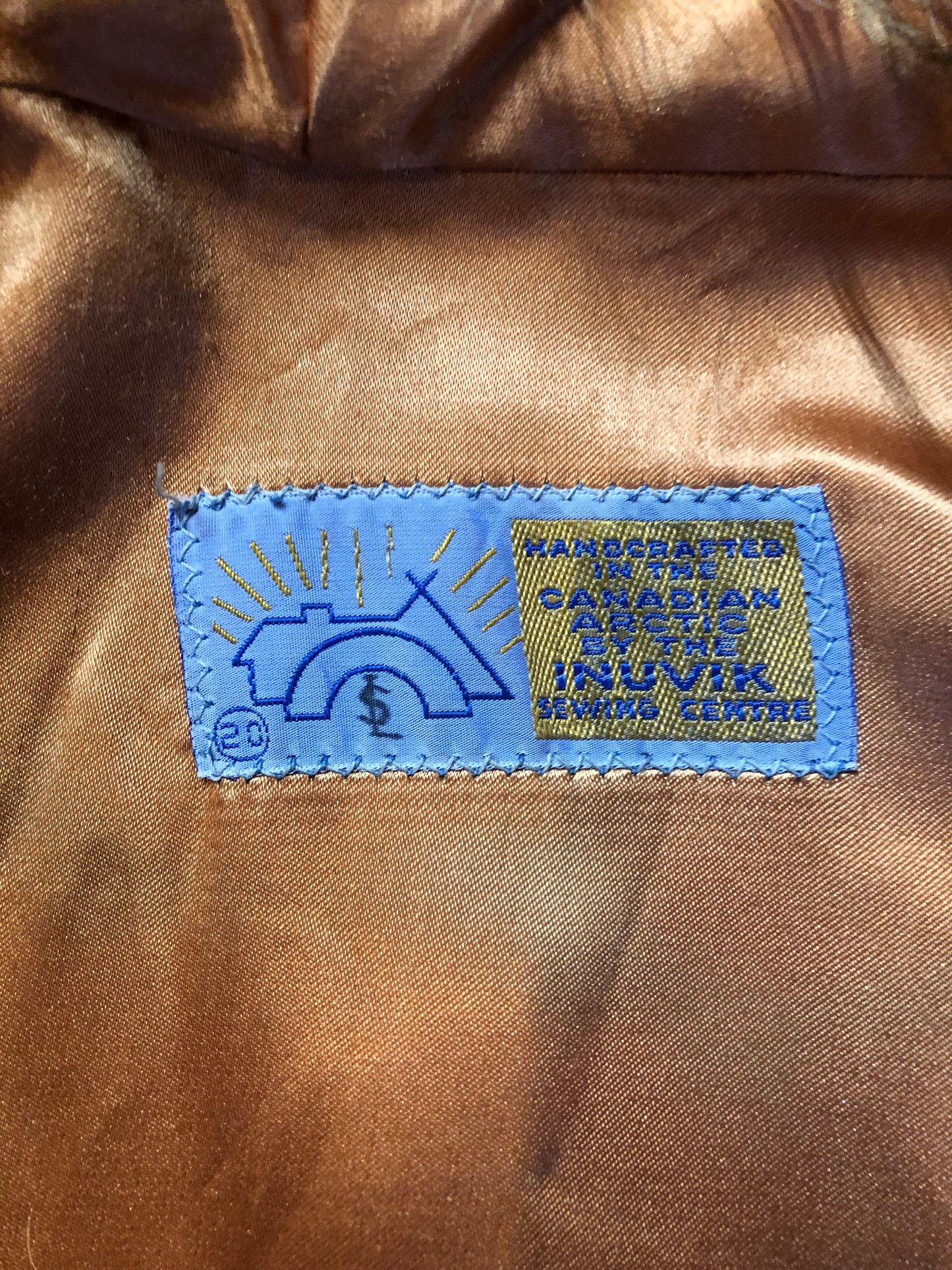 Vintage Inuvik Sewing Company brown 100% pure wool parka. This parka features a cotton/ polyester blend storm shell with embroidered details, a fur trimmed hood, zipper closure, patch pockets, satin lining and a snowshoeing design in felt applique. Made in northern Canada - Kingspier Vintage