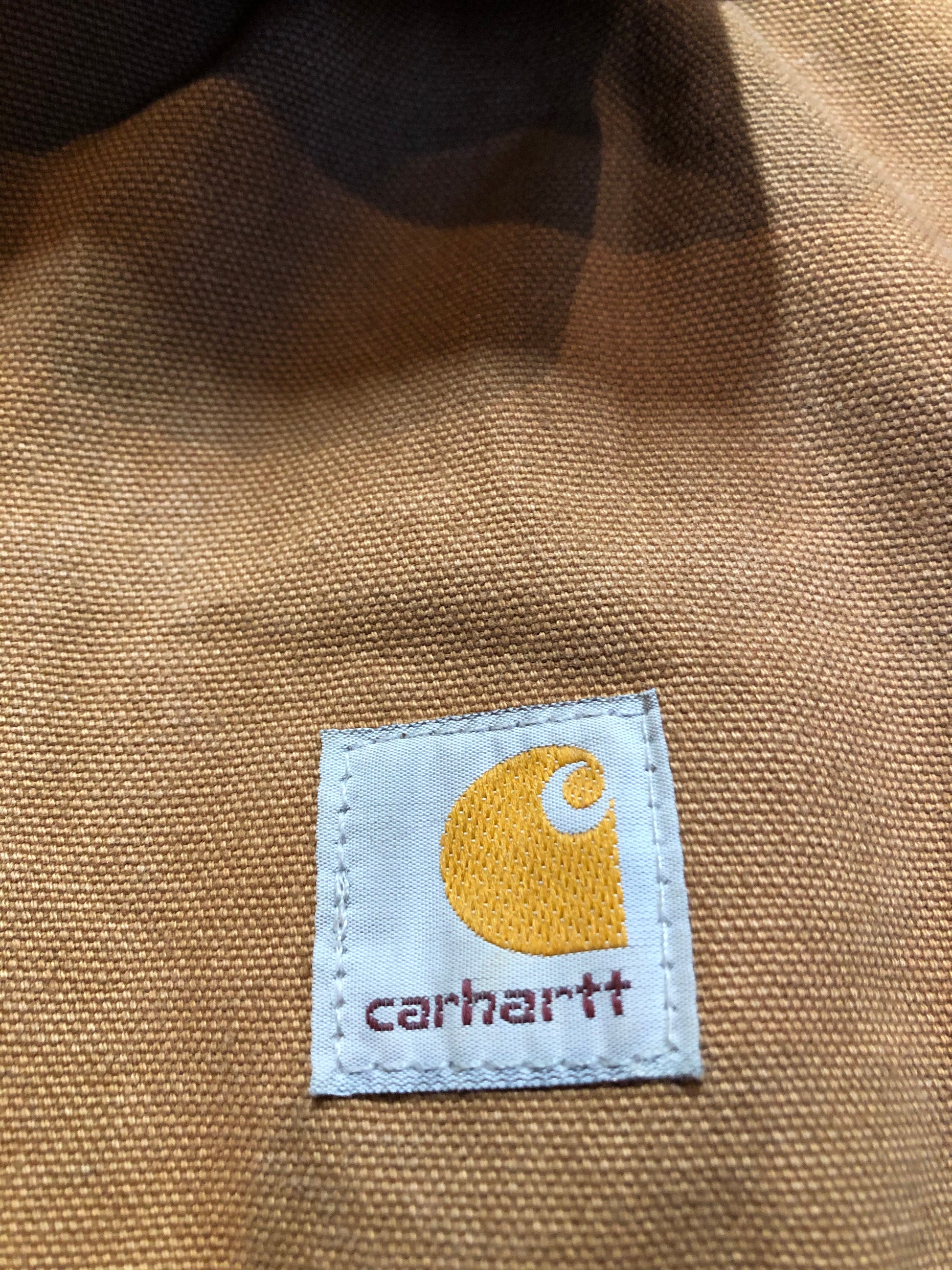 Kingspier Vintage - Kids Carhartt Chore Jacket in Tan Brown with Brown corduroy collar, zipper closure, slash pockets, knit inner cuffs and red quilted lining. Made in the USA. Size childrens 6.