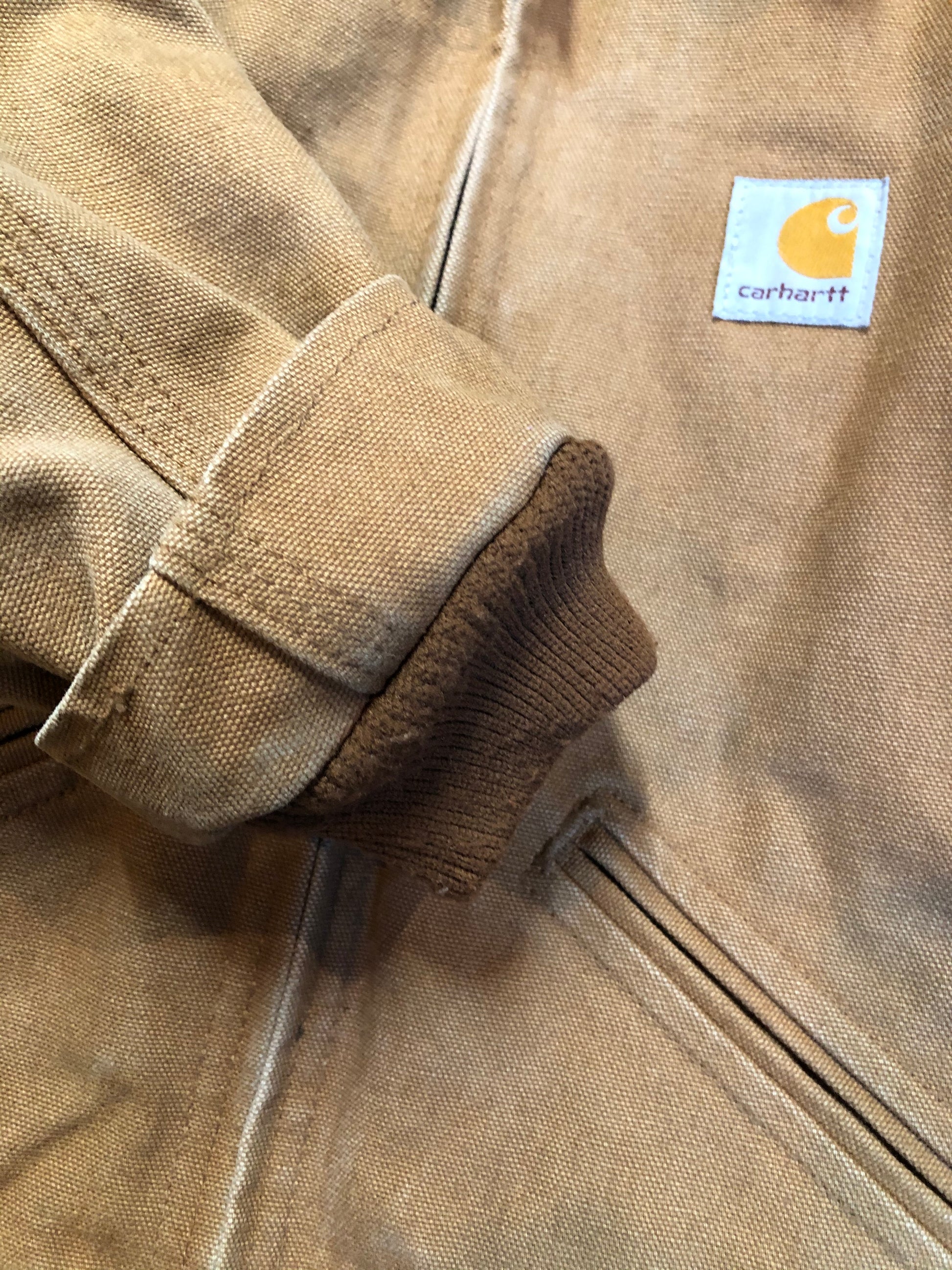 Kingspier Vintage - Kids Carhartt Chore Jacket in Tan Brown with Brown corduroy collar, zipper closure, slash pockets, knit inner cuffs and red quilted lining. Made in the USA. Size childrens 6.