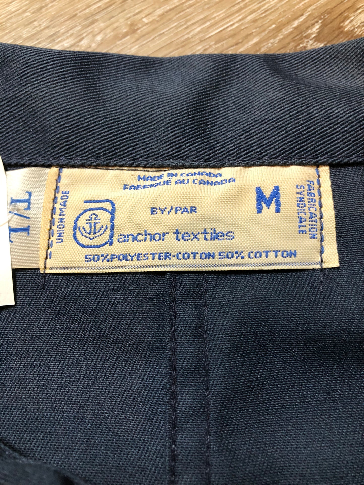 Kingspier Vintage - Vintage Deadstock Anchor Textiles navy coveralls with snap closures, flap pockets on the chest, slash pockets in the front and patch pockets in the back. Union made in Canada. Size medium/ tall.