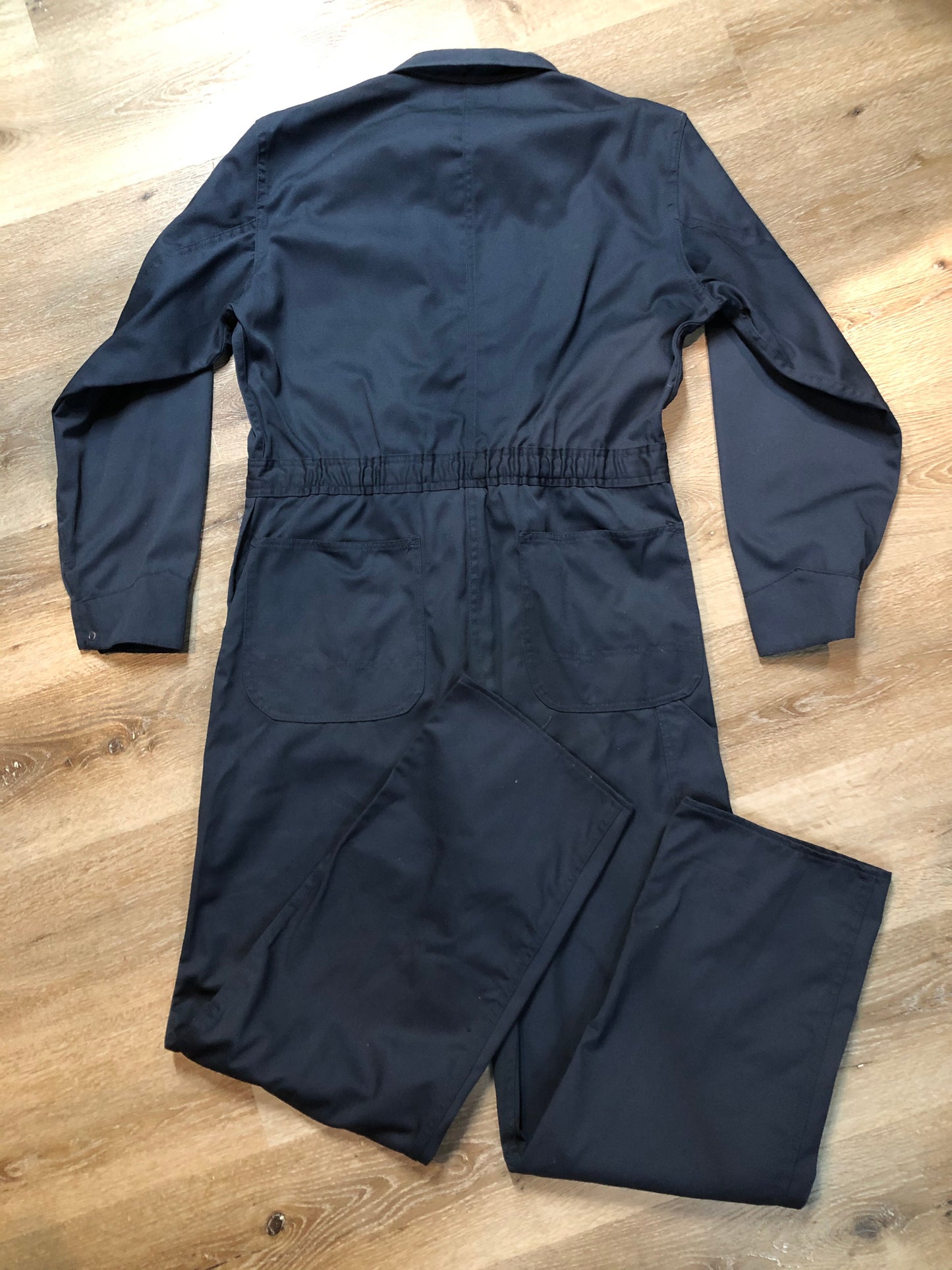 Kingspier Vintage - Vintage Deadstock Anchor Textiles navy coveralls with snap closures, flap pockets on the chest, slash pockets in the front and patch pockets in the back. Union made in Canada. Size medium/ tall.