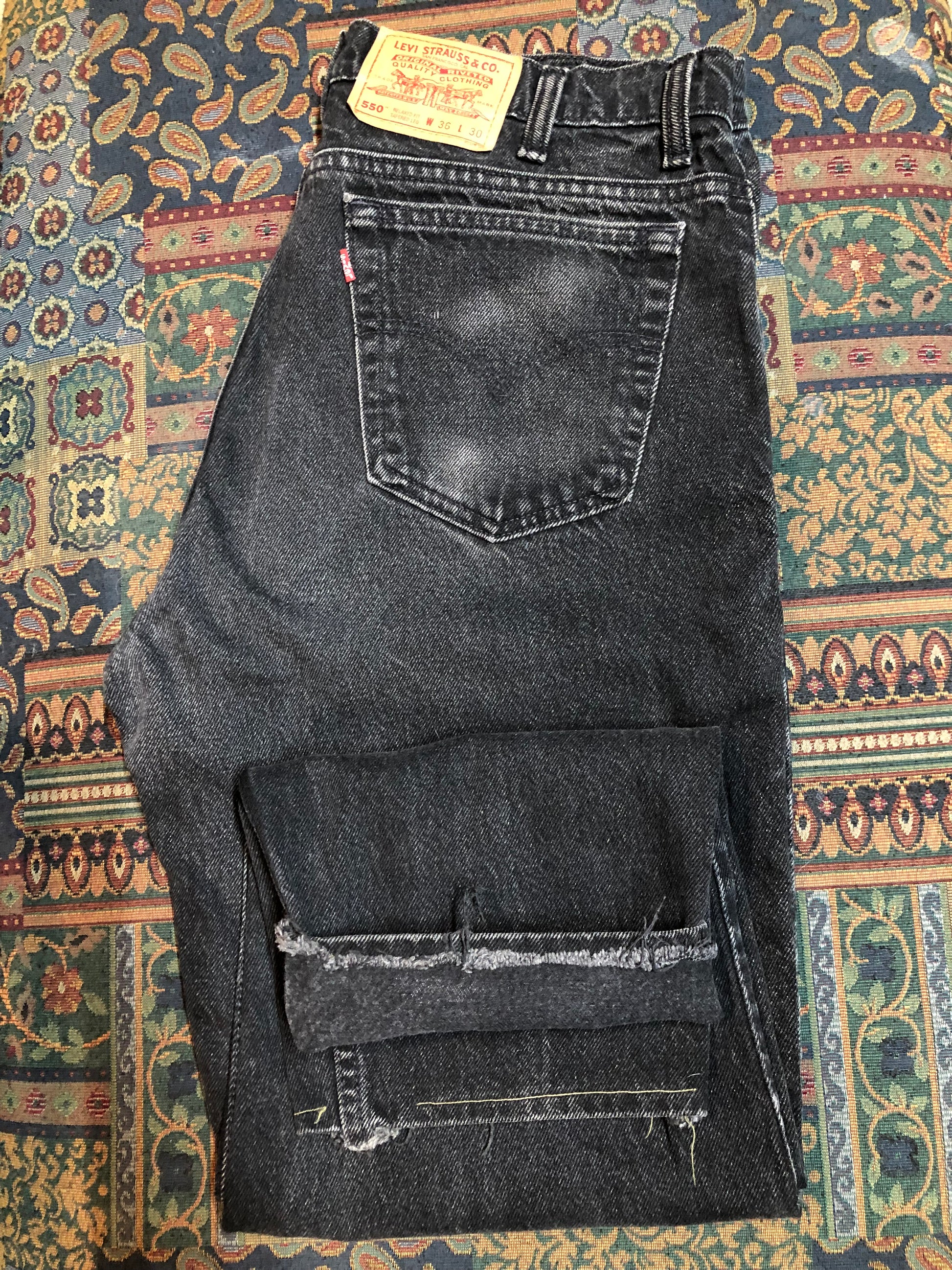 Levi’s 550 - 36”x28” Black Denim Jeans  Vintage Red Tab  High rise  Button fly  Tapered leg  Tagged 36”x30”  100% Cotton  Button stamped “217”  Made in Canada - Kingspier Vintage